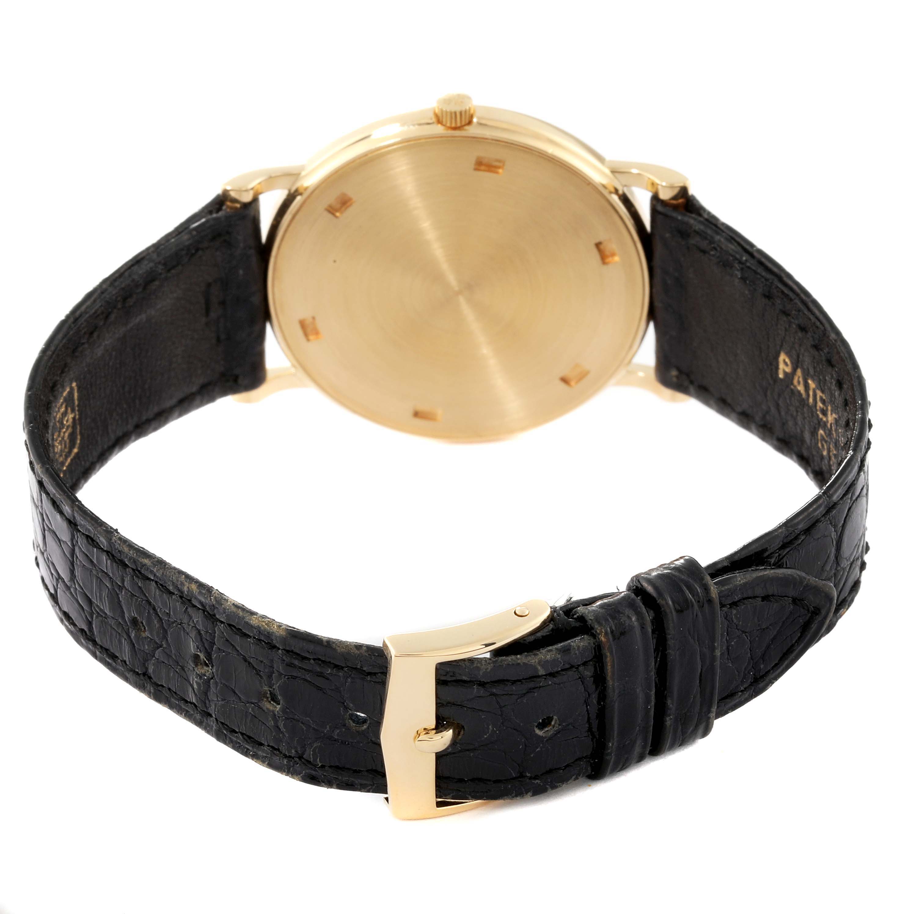 The image shows the rear view of a Patek Philippe Calatrava 3520D Men's Yellow Gold Beige Dial 3520D Men's Yellow Gold Beige Dial watch with a leather strap and gold buckle.