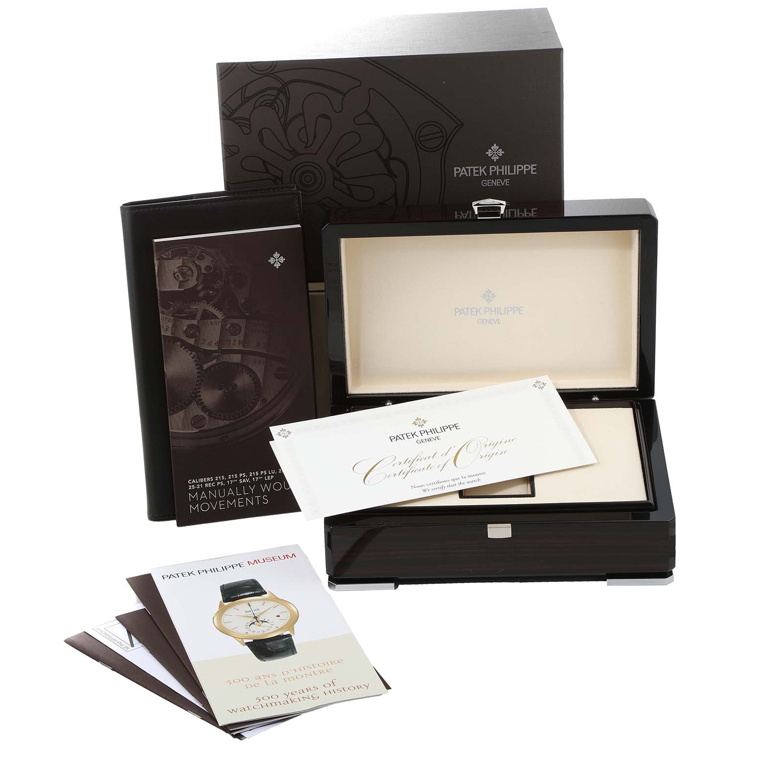 The image shows packaging accessories of the Patek Philippe Calatrava 5119G Men
s White Gold White Dial 5119G Men
s White Gold White Dial watch, including the box, certificate, and booklets.
