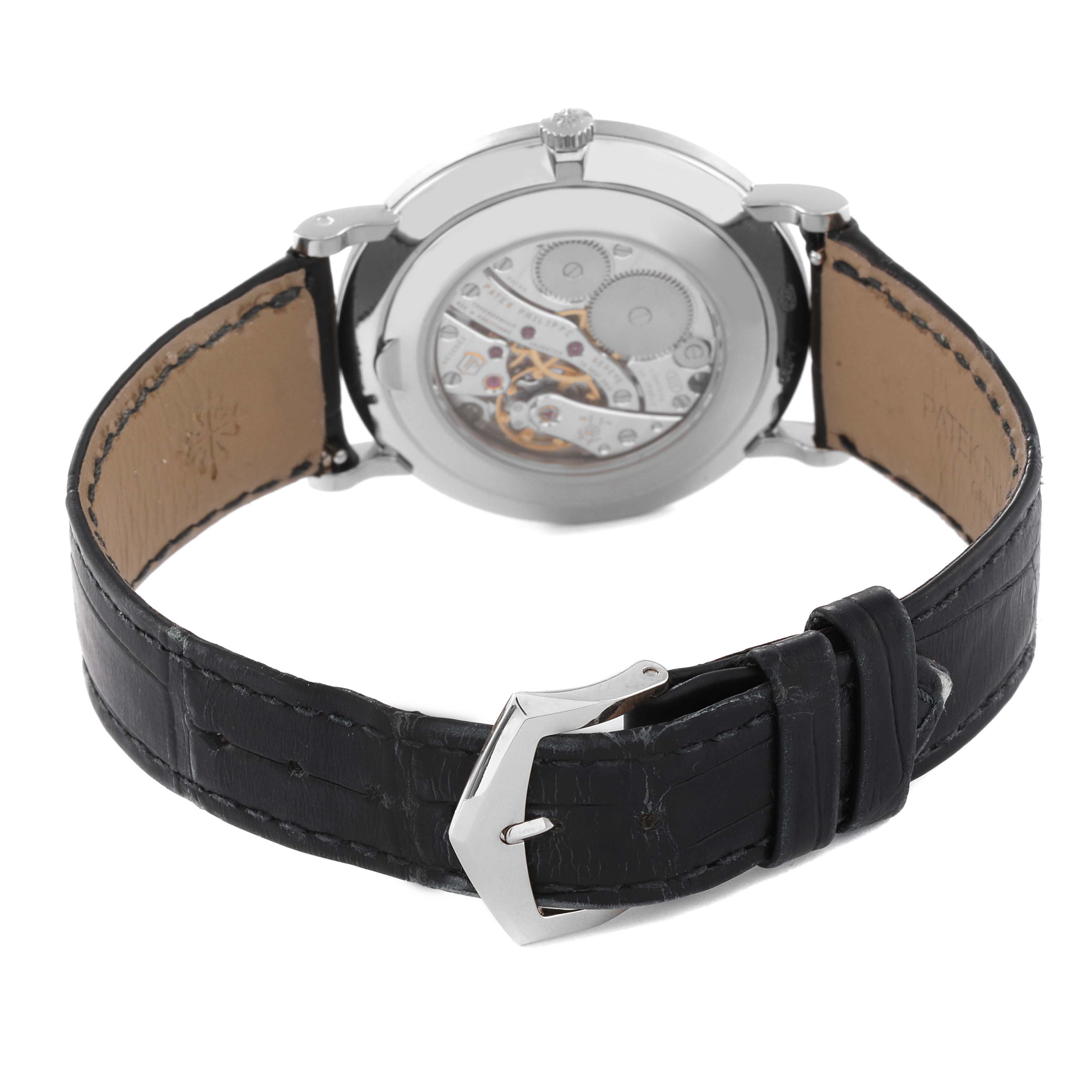This image shows the back of a Patek Philippe Calatrava 5119G Men
s White Gold White Dial 5119G Men
s White Gold White Dial watch, highlighting the movement and black leather strap.
