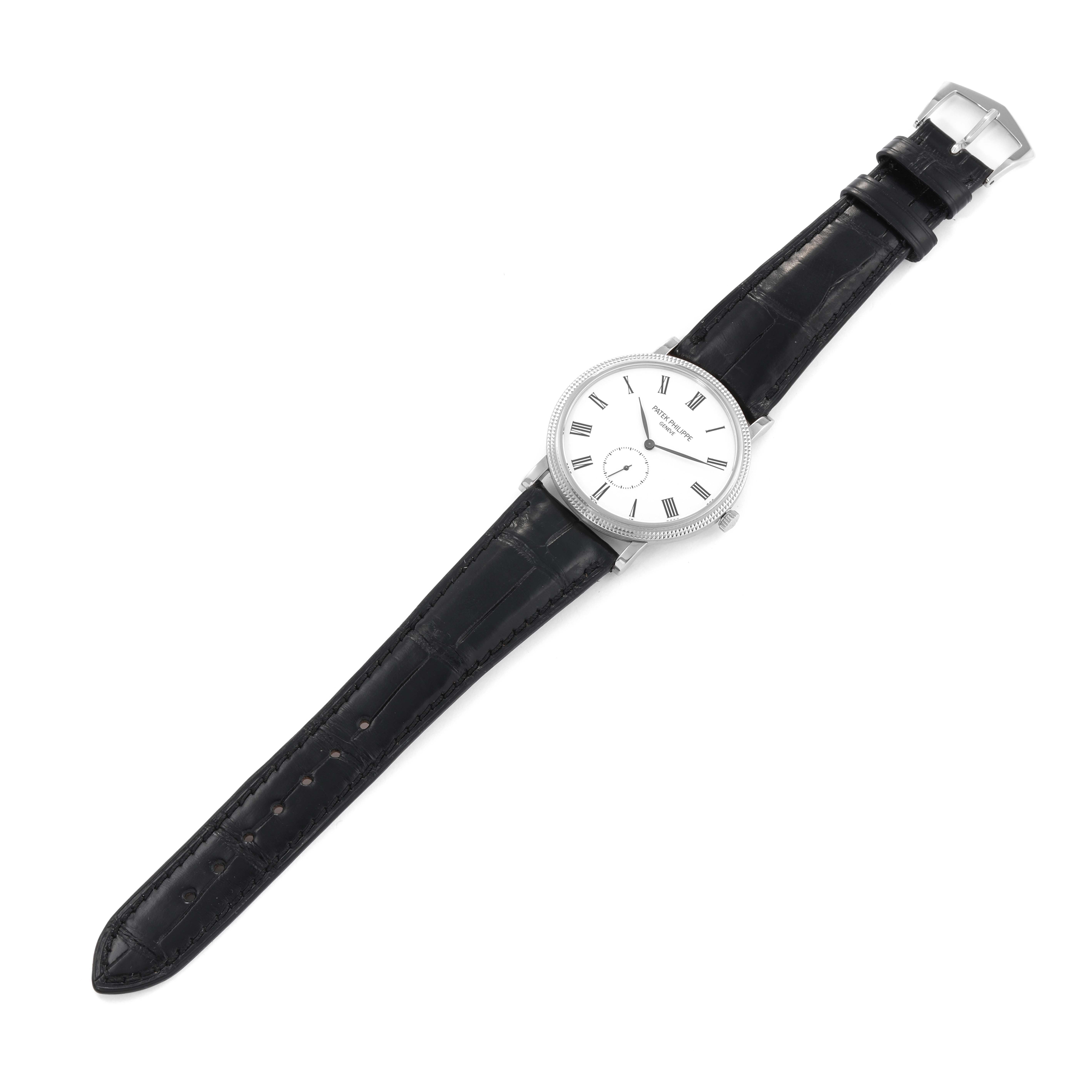The image shows a Patek Philippe Calatrava 5116G Men's White Gold White Dial 5116G Men's White Gold White Dial watch at a top-down angle, displaying the watch face and entire black leather strap.