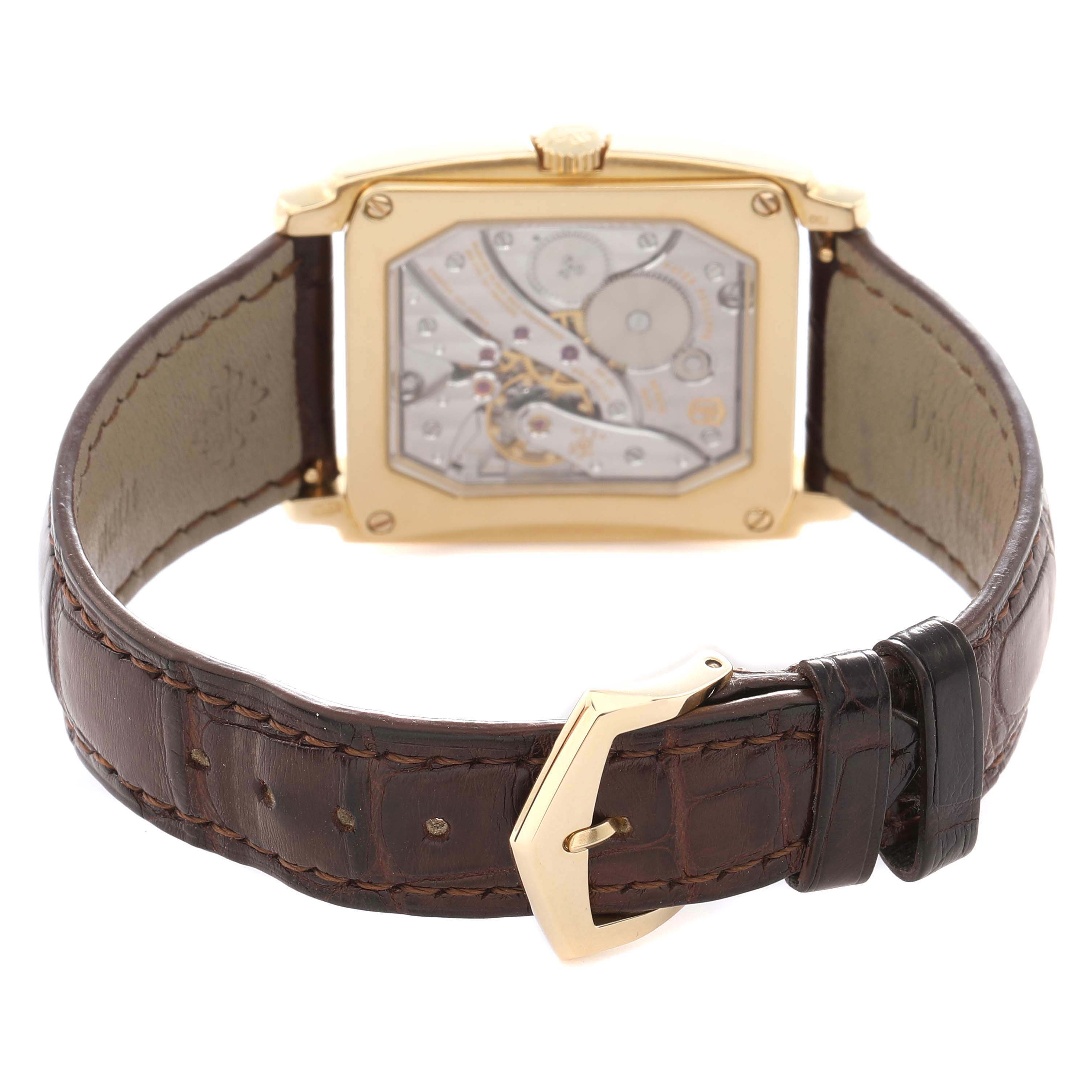 The image shows the back view of a Patek Philippe Gondolo 5124J-001 Men
s Yellow Gold Silver Dial 5124J-001 Men
s Yellow Gold Silver Dial watch, displaying the movement and caseback, with a leather strap and buckle.