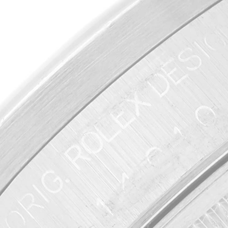 The image shows an extreme close-up of the engraved side of the bezel of a Rolex Air-King 14010 Men's Stainless Steel Silver Dial 14010 Men's Stainless Steel Silver Dial watch.