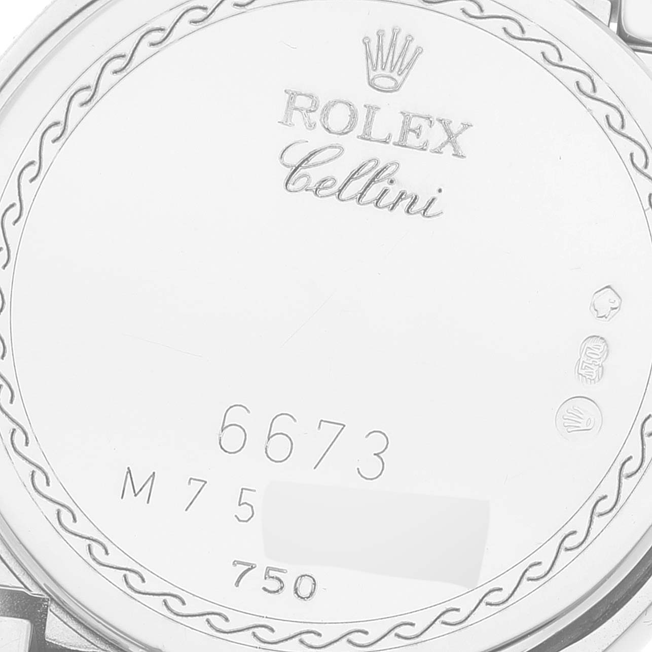 This image shows the back casing of a Rolex Cellini 6673 Women's White Gold Silver Dial 6673 Women's White Gold Silver Dial watch with engraved details and hallmarks.