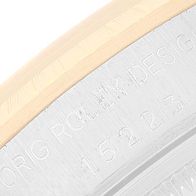 This close-up image shows the case side and bezel of a Rolex Date 15223 Men's Steel and Gold (two tone) White Dial 15223 Men's Steel and Gold (two tone) White Dial model, featuring engraved text.