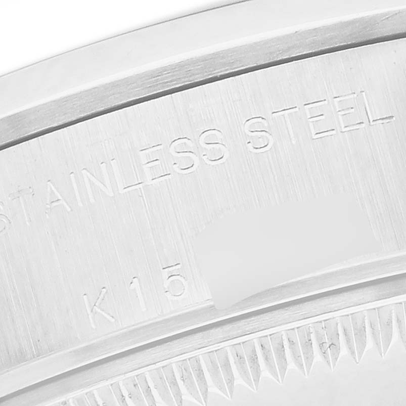 The image shows a close-up of the stainless steel case back edge of the Rolex Date 79160 Women
s Stainless Steel Silver Dial 79160 Women
s Stainless Steel Silver Dial model, featuring engraved text.