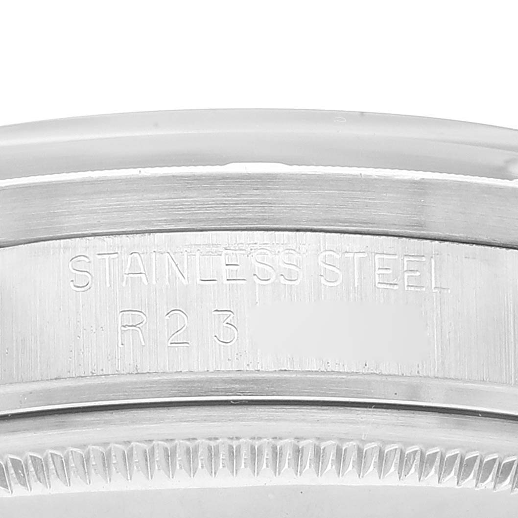 This close-up image shows the casing and part of the engraving on a stainless steel Rolex Date 15010 Men's Stainless Steel Black Dial 15010 Men's Stainless Steel Black Dial model watch.