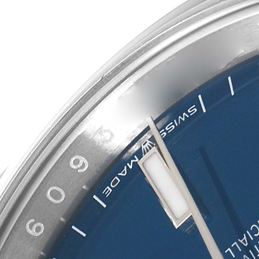 The image shows a close-up of the dial, bezel, and part of the hand of a Rolex Datejust 126200 Men's Stainless Steel Blue Dial 126200 Men's Stainless Steel Blue Dial watch.