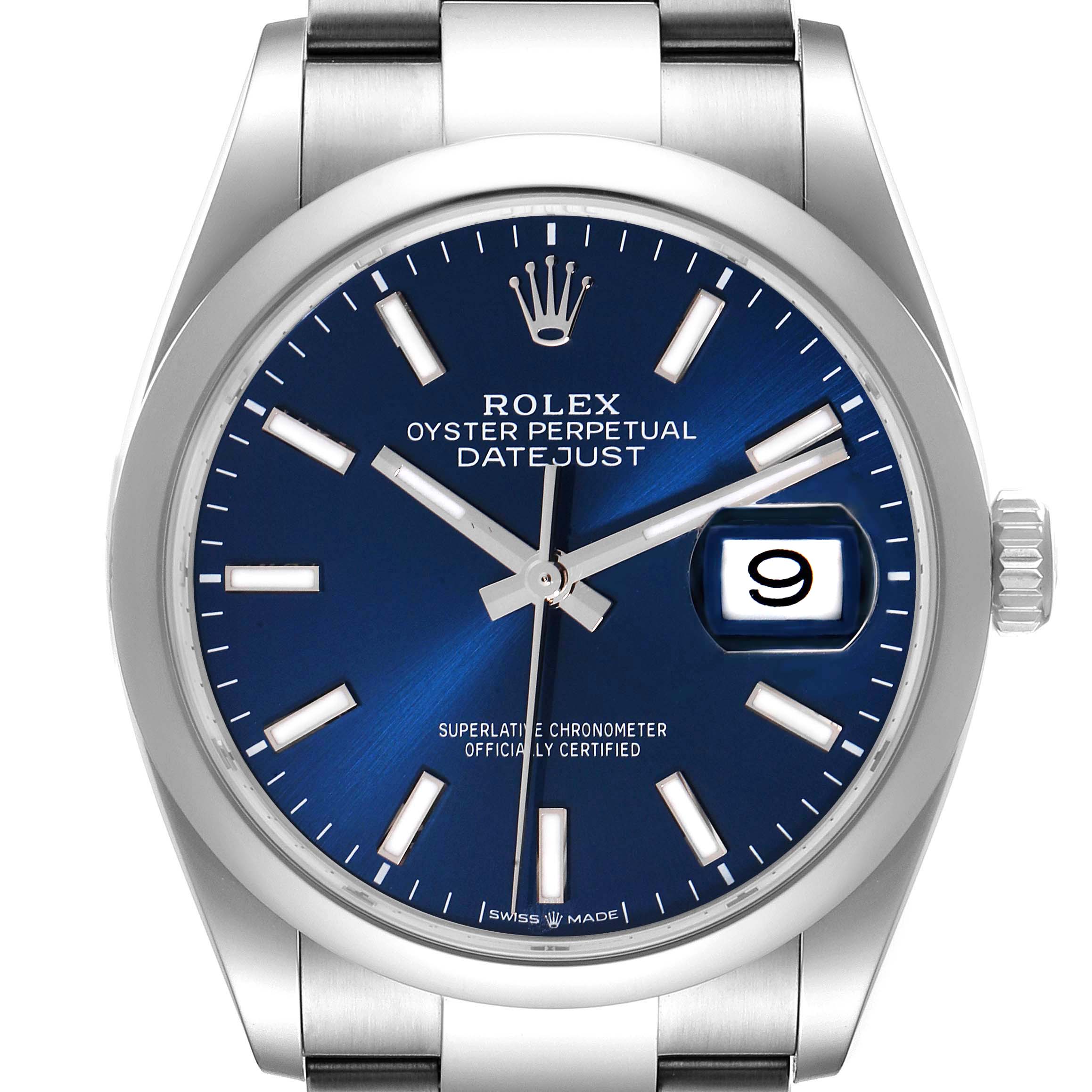 The Rolex Datejust 126200 Men's Stainless Steel Blue Dial 126200 Men's Stainless Steel Blue Dial watch is shown from a straight-on angle, displaying the dial, hands, bezel, and part of the bracelet.