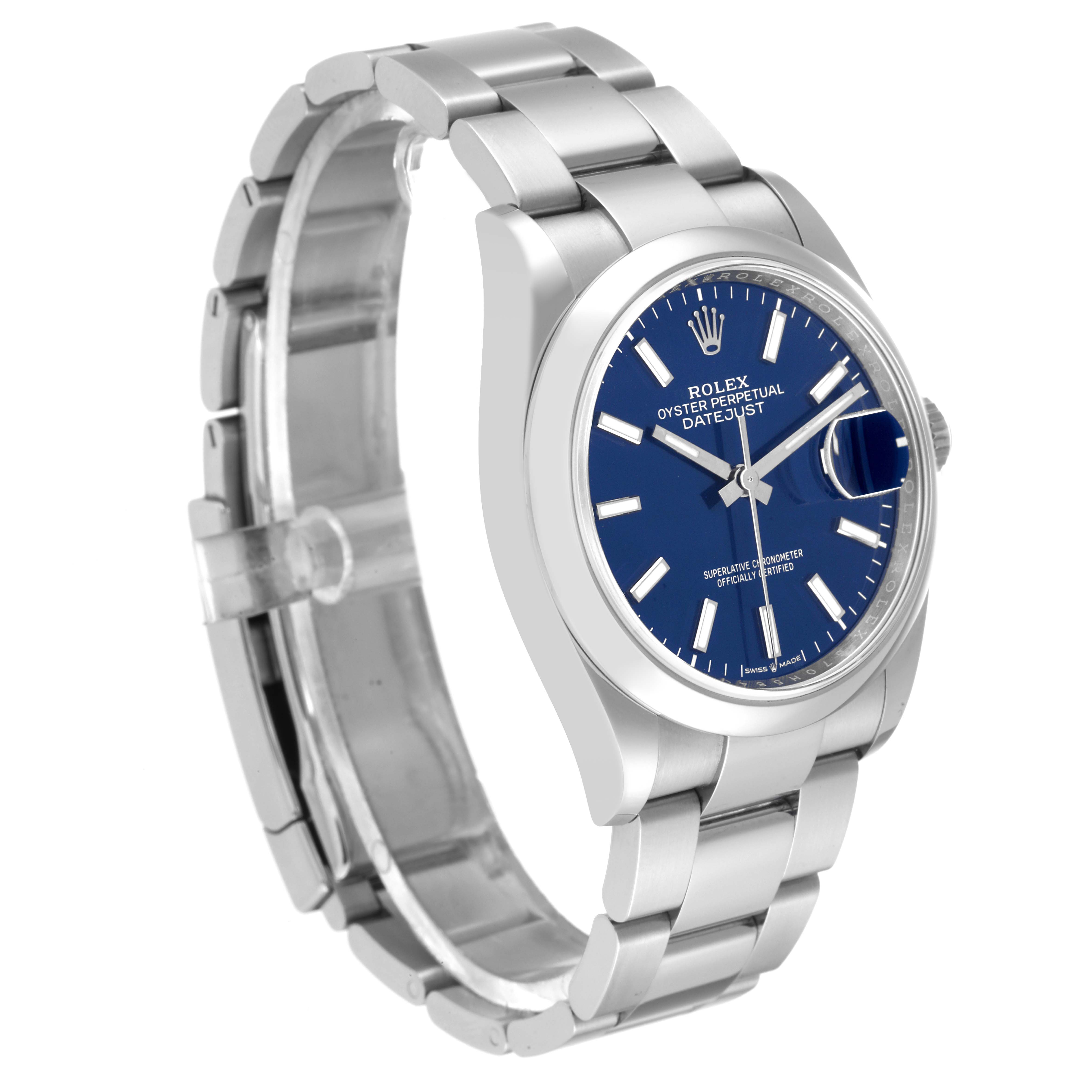 The image shows a Rolex Datejust 126200 Men's Stainless Steel Blue Dial 126200 Men's Stainless Steel Blue Dial watch at a three-quarter angle, highlighting its bracelet, blue dial, and stainless steel case.