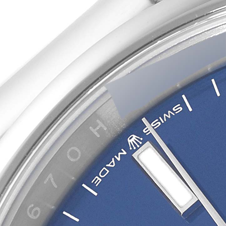 This close-up image of a Rolex Datejust 126200 Men's Stainless Steel Blue Dial 126200 Men's Stainless Steel Blue Dial watch shows a portion of the blue dial and the "Swiss Made" marking.