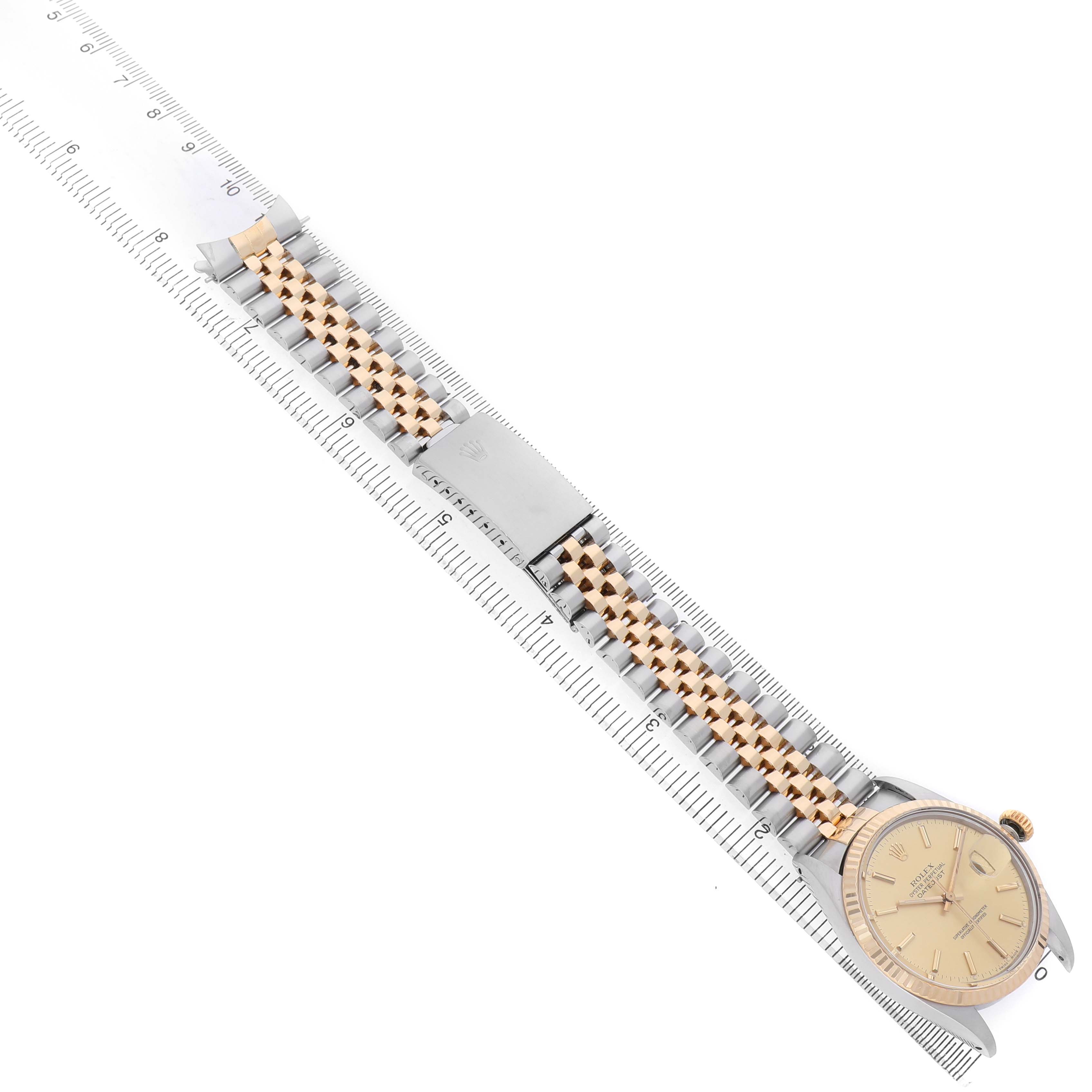 The Rolex Datejust 16013 Men's Steel and Gold (two tone) Champagne Dial watch is shown from an overhead angle, displaying the face, bracelet, and clasp.