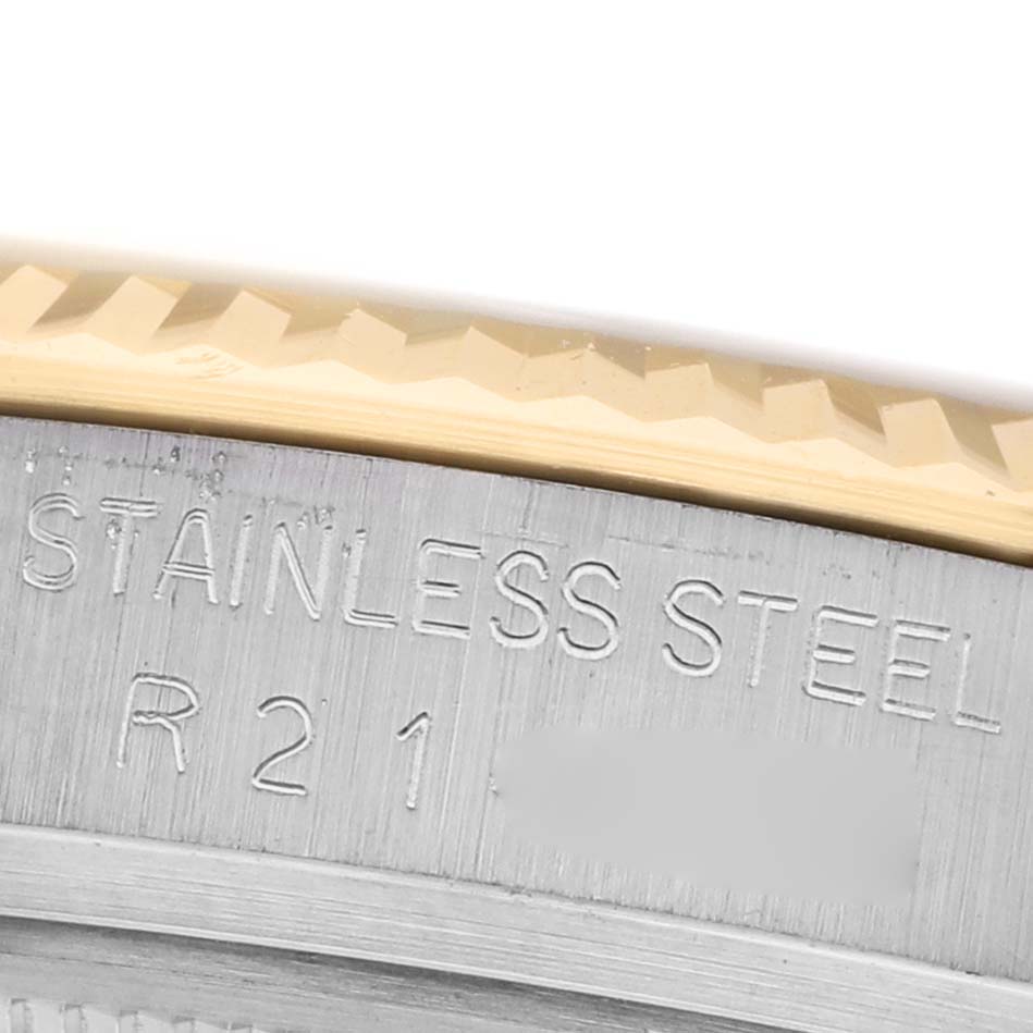 The image shows a close-up of the bezel and part of the case of a Rolex Datejust 16013 Men's Steel and Gold (two tone) Champagne Dial with "STAINLESS STEEL" engraved.