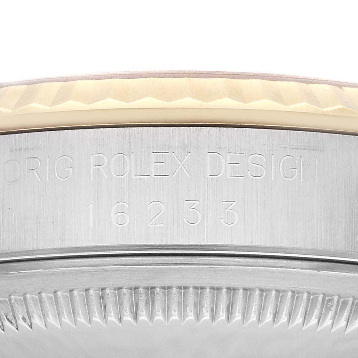 The image shows a close-up of the side of the Rolex Datejust 16233 Men's Steel and Gold (two tone) Silver Dial 16233 Men's Steel and Gold (two tone) Silver Dial model, specifically focusing on the engraved serial number and bezel detail.