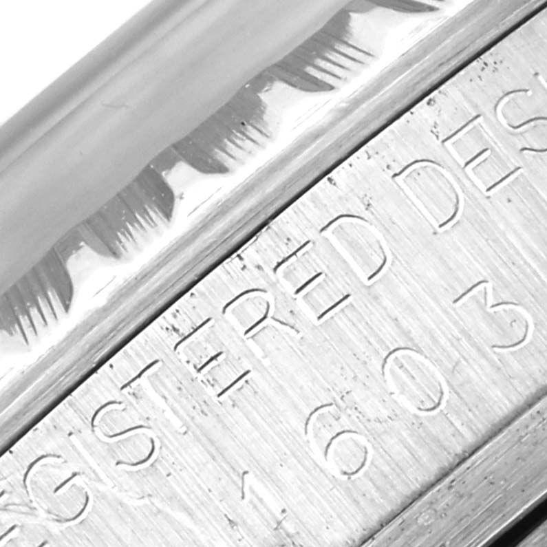 Close-up angle of a Rolex Vintage Collection 1603 Men's Stainless Steel Blue Dial 1603 Men's Stainless Steel Blue Dial model showing the edge with engraved text detailing the watch's unique identifier.