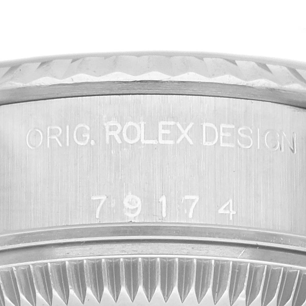 This image shows a close-up of the side of a Rolex Datejust 79174 Women's Stainless Steel Blue Dial 79174 Women's Stainless Steel Blue Dial watch, highlighting the model number and design engravings.