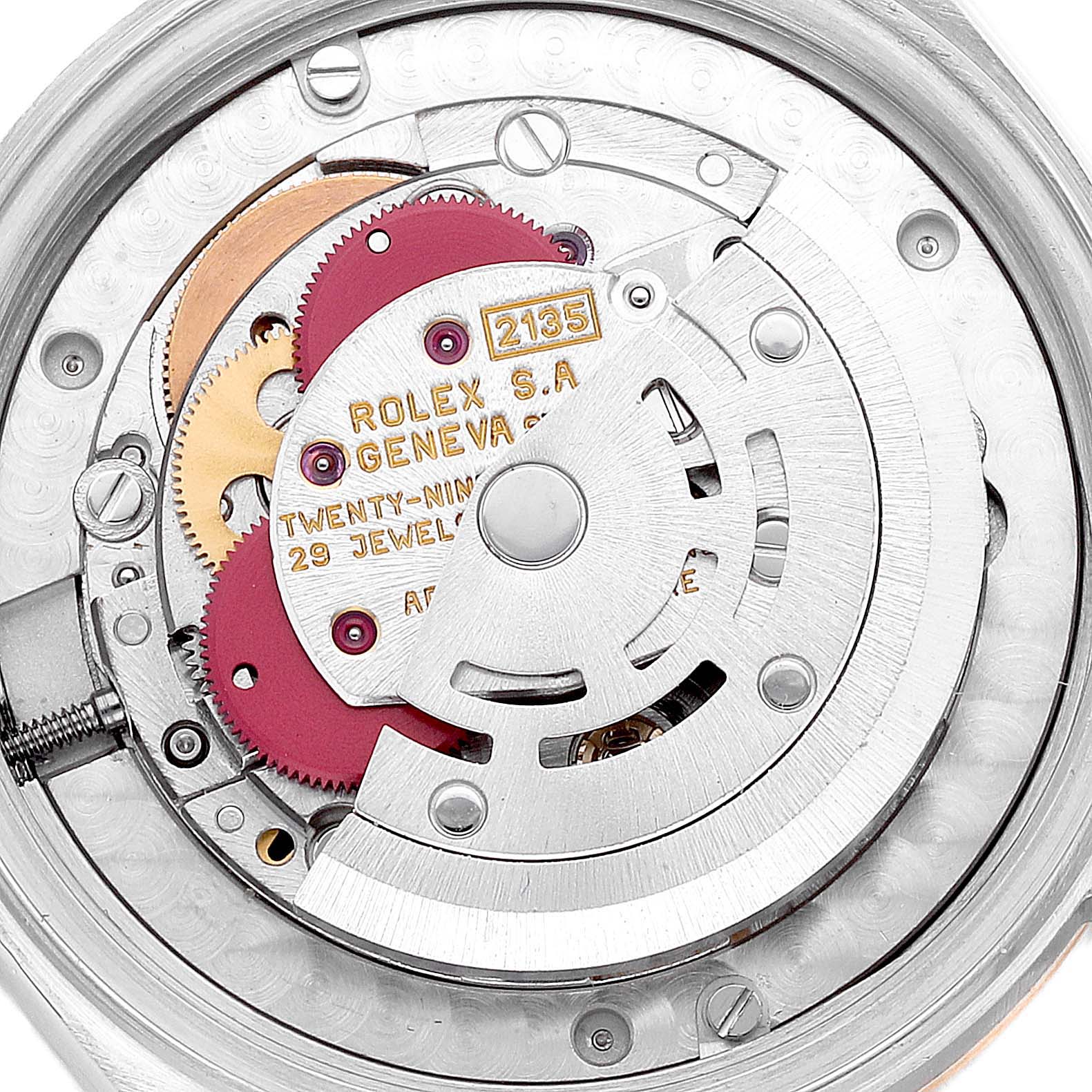 The image shows the inner mechanism and movement of a Rolex Mid-Size 68273 Women's Steel and Gold (two tone) Grey Dial 68273 Women's Steel and Gold (two tone) Grey Dial Model watch, displaying gears, jewels, and the rotor.