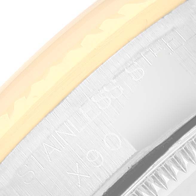 Close-up of the bezel and case of a Mid-Size Rolex watch, showing the "STAINLESS STEEL" engraving.