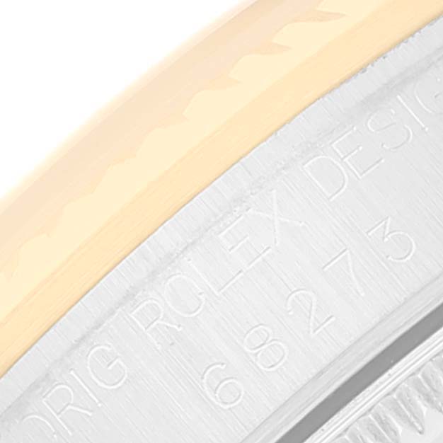 The image shows a close-up of the side view of a Mid-Size Rolex watch, focusing on the engraved bezel and casing.