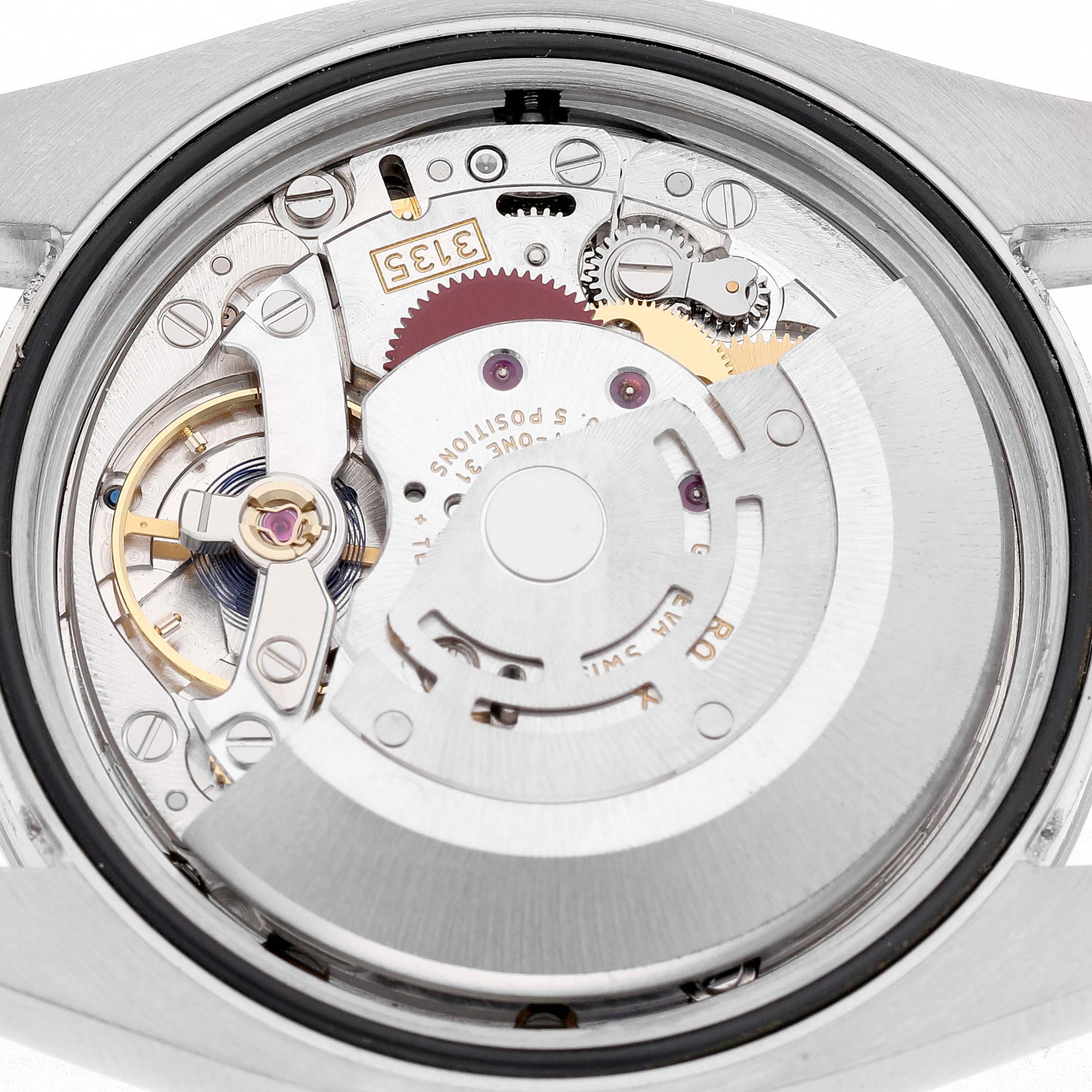 The image shows the movement of a Rolex Datejust 116200 Men's Stainless Steel White Dial watch from a top-down angle, featuring its intricate internal components.