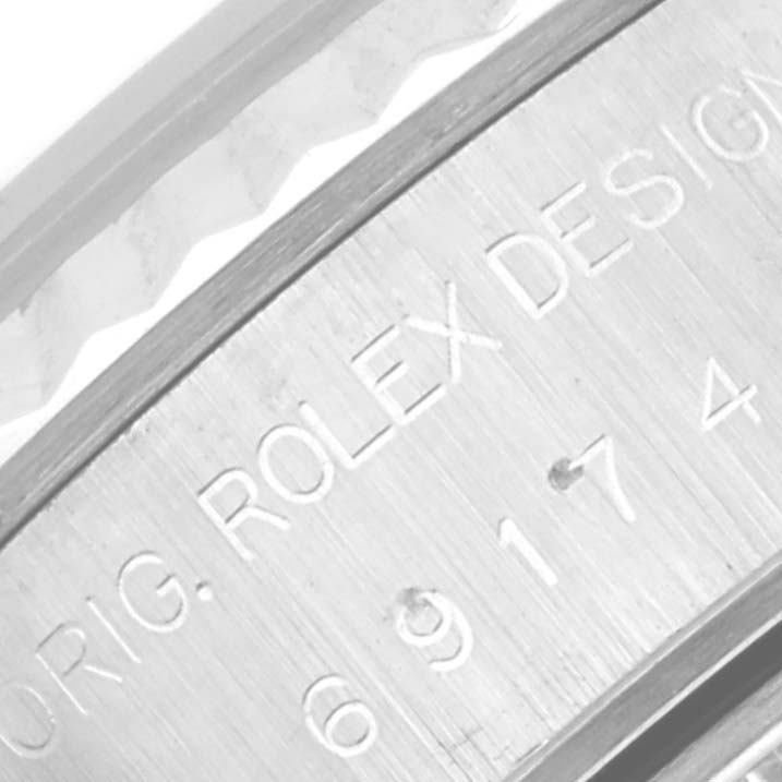 The image shows a close-up angle of the side engraving on a Rolex Datejust 69174 Women's Stainless Steel White Dial 69174 Women's Stainless Steel White Dial watch.