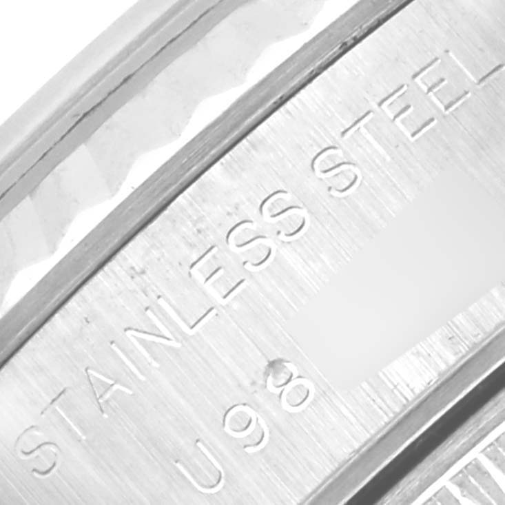 This image shows an extreme close-up of the stainless steel casing of a Rolex Datejust 69174 Women's Stainless Steel White Dial 69174 Women's Stainless Steel White Dial watch with a partial serial number.