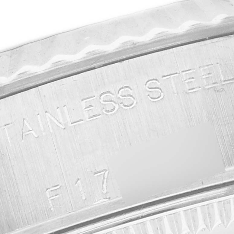 The image shows a close-up of the engraved text "STAINLESS STEEL" on the side of the Rolex Datejust 79174 Women's Stainless Steel Mother of Pearl Dial 79174 Women's Stainless Steel Mother of Pearl Dial watch, focusing on the case edge.