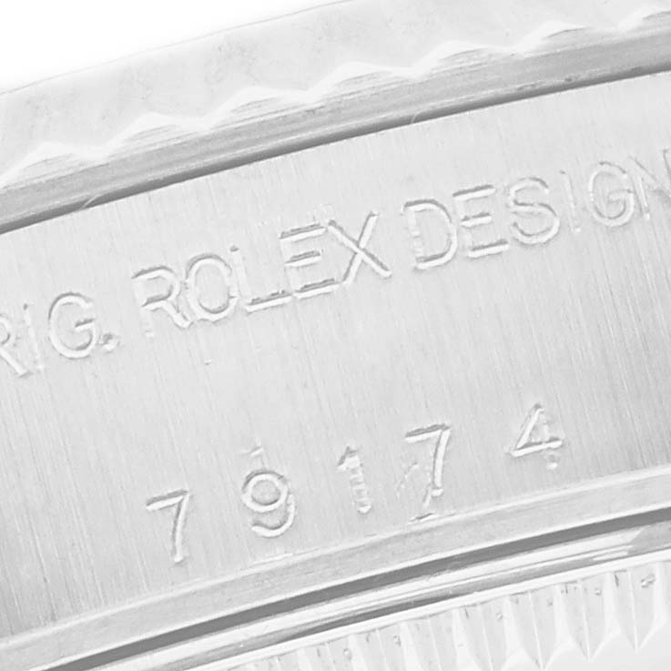 The image shows an angled close-up of the engraved bezel of a Rolex Datejust 79174 Women's Stainless Steel Mother of Pearl Dial 79174 Women's Stainless Steel Mother of Pearl Dial, highlighting design details.