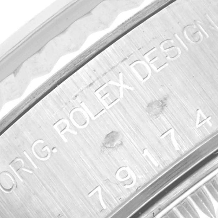 The image shows the engraved side of a Rolex Datejust 79174 Women's Stainless Steel Mother of Pearl Dial 79174 Women's Stainless Steel Mother of Pearl Dial watch case, highlighting the brand and design number.