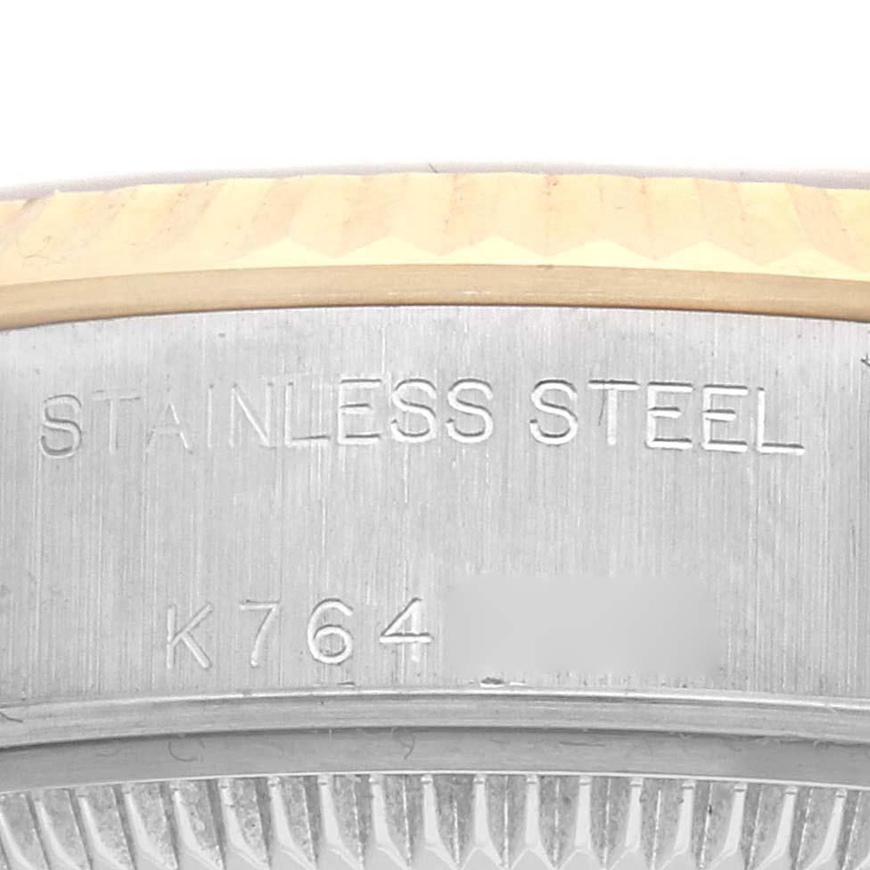 The image shows a close-up of the case side of a Rolex Datejust 79173 Women's Steel and Gold (two tone) Silver Dial 79173 Women's Steel and Gold (two tone) Silver Dial, highlighting the stainless steel engraving and fluted bezel.