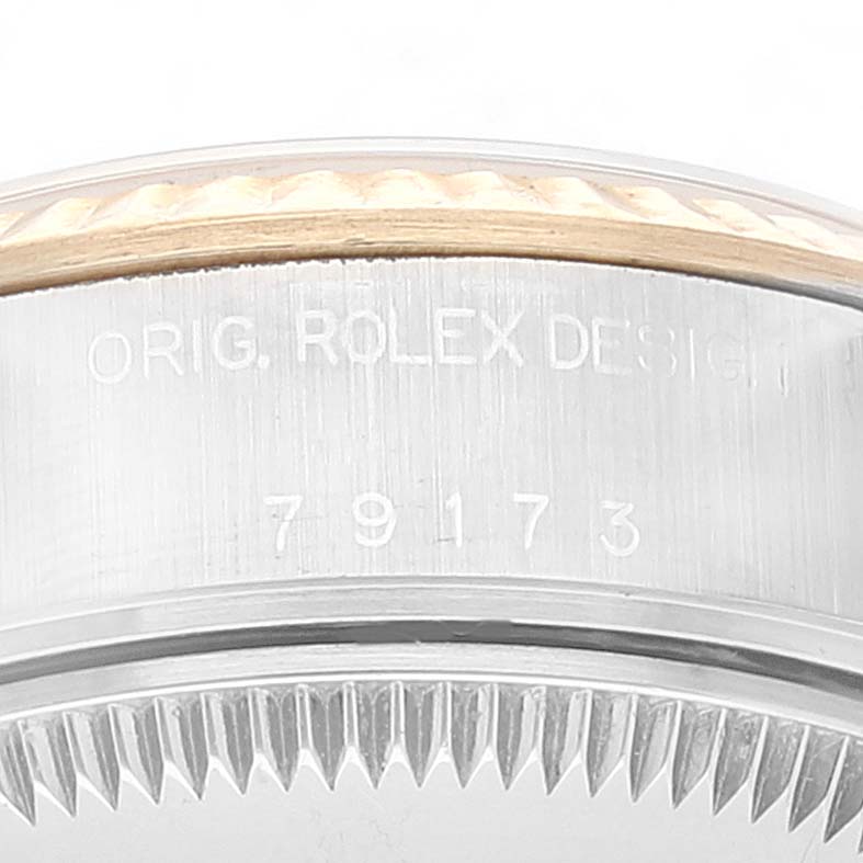 This image displays a close-up of the side of a Rolex Datejust 79173 Women's Steel and Gold (two tone) Black Dial 79173 Women's Steel and Gold (two tone) Black Dial watch, showing the engravings and part of the bezel.