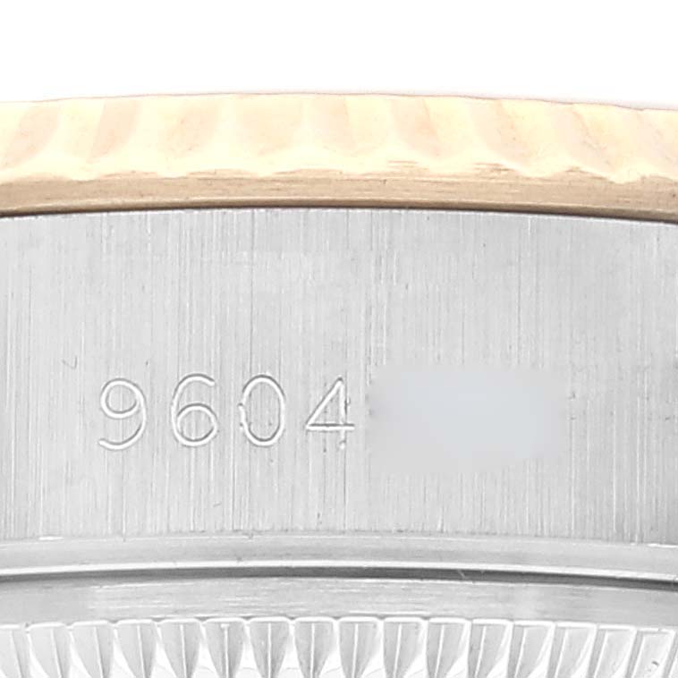 This image shows a close-up angle of the bezel and case side, including a partial serial number, of a Rolex Datejust 69173 Women's Steel and Gold (two tone) Champagne Dial 69173 Women's Steel and Gold (two tone) Champagne Dial watch.