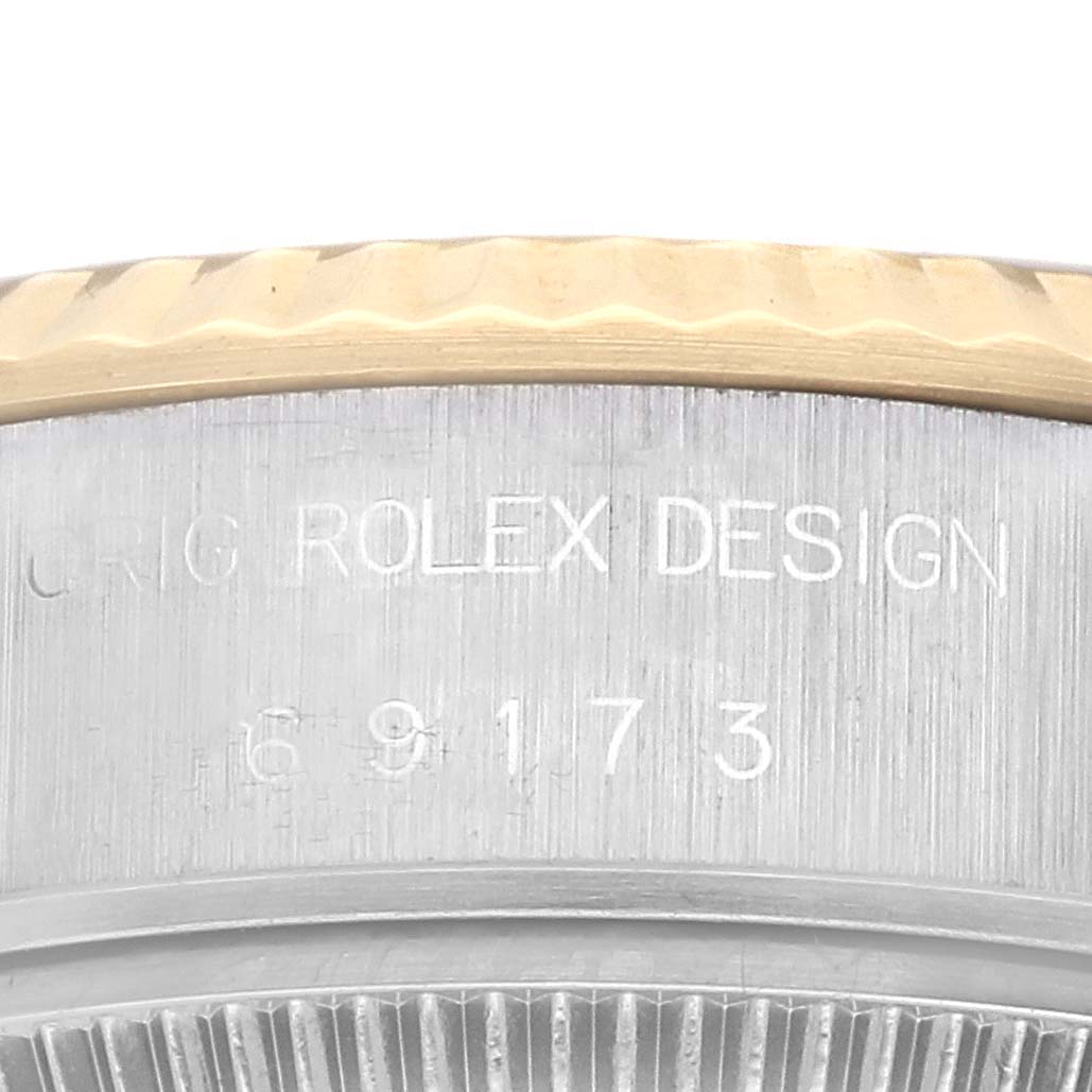 This close-up shows the Rolex branding and model number engraving on the side of the Datejust's watch case.
