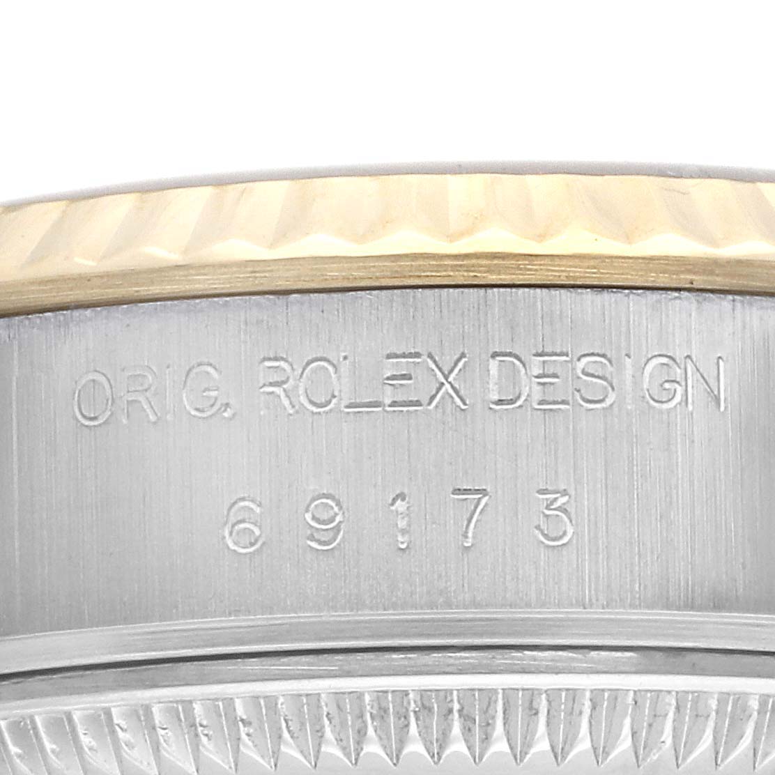 The image shows a close-up angle of the Rolex Datejust 69173 Women's Steel and Gold (two tone) Champagne Dial 69173 Women's Steel and Gold (two tone) Champagne Dial model bezel and side case with engraved text and reference number.