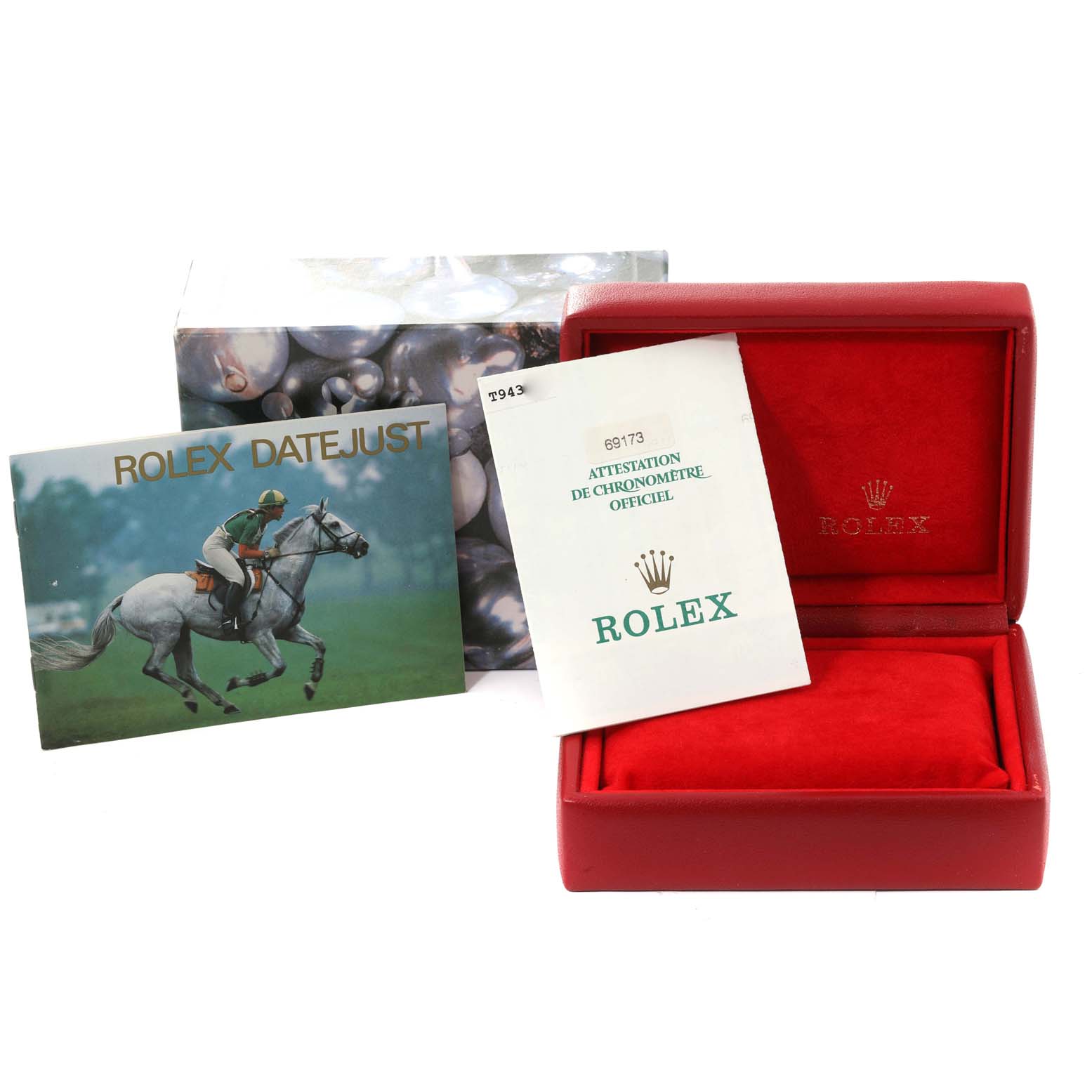 The image shows accessories for a Rolex Datejust 69173 Women's Steel and Gold (two tone) Champagne Dial 69173 Women's Steel and Gold (two tone) Champagne Dial, including a booklet, certificate, and an empty red watch box.