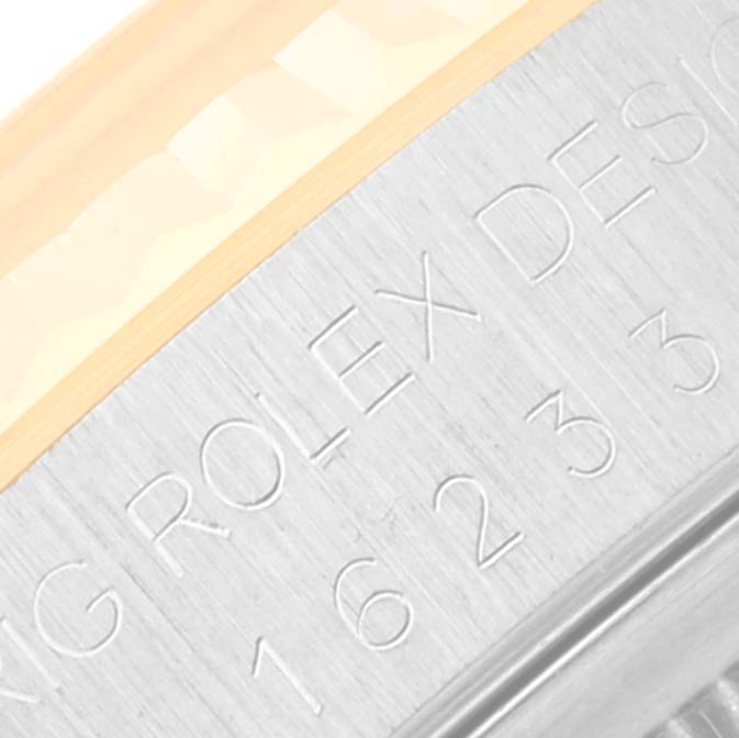 This image shows a close-up of the engraved side casing of a Rolex Datejust 16233 Men's Steel and Gold (two tone) Beige Dial 16233 Men's Steel and Gold (two tone) Beige Dial watch.