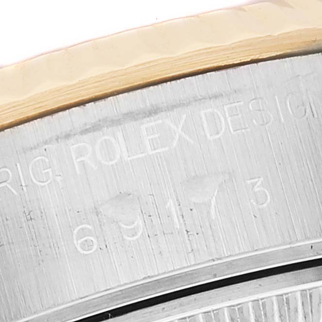 This close-up shows the engraved details of the serial number on the case of a Rolex Datejust 69173 Women's Steel and Gold (two tone) Mother of Pearl Dial 69173 Women's Steel and Gold (two tone) Mother of Pearl Dial watch.