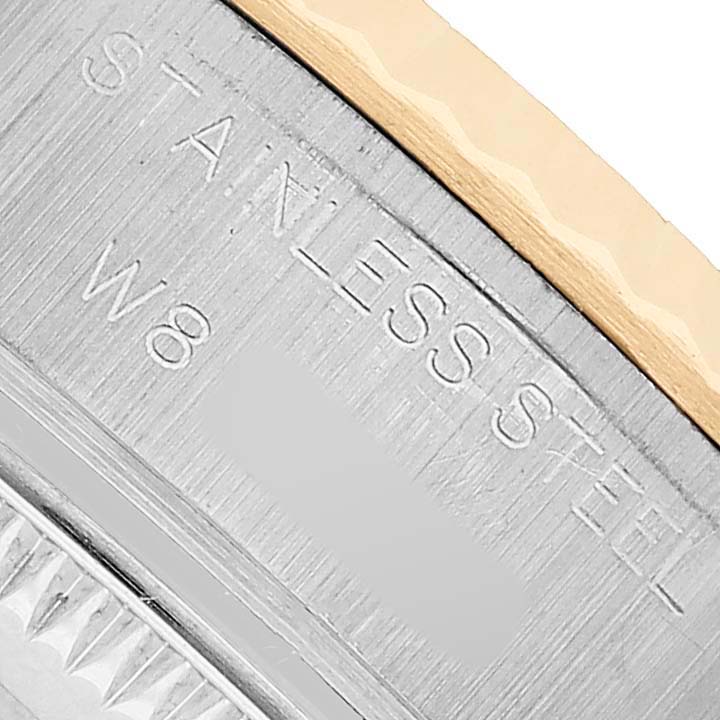 The image shows a close-up of the case side of a Rolex Datejust 69173 Women's Steel and Gold (two tone) Silver Dial, highlighting the "STAINLESS STEEL" engraving.