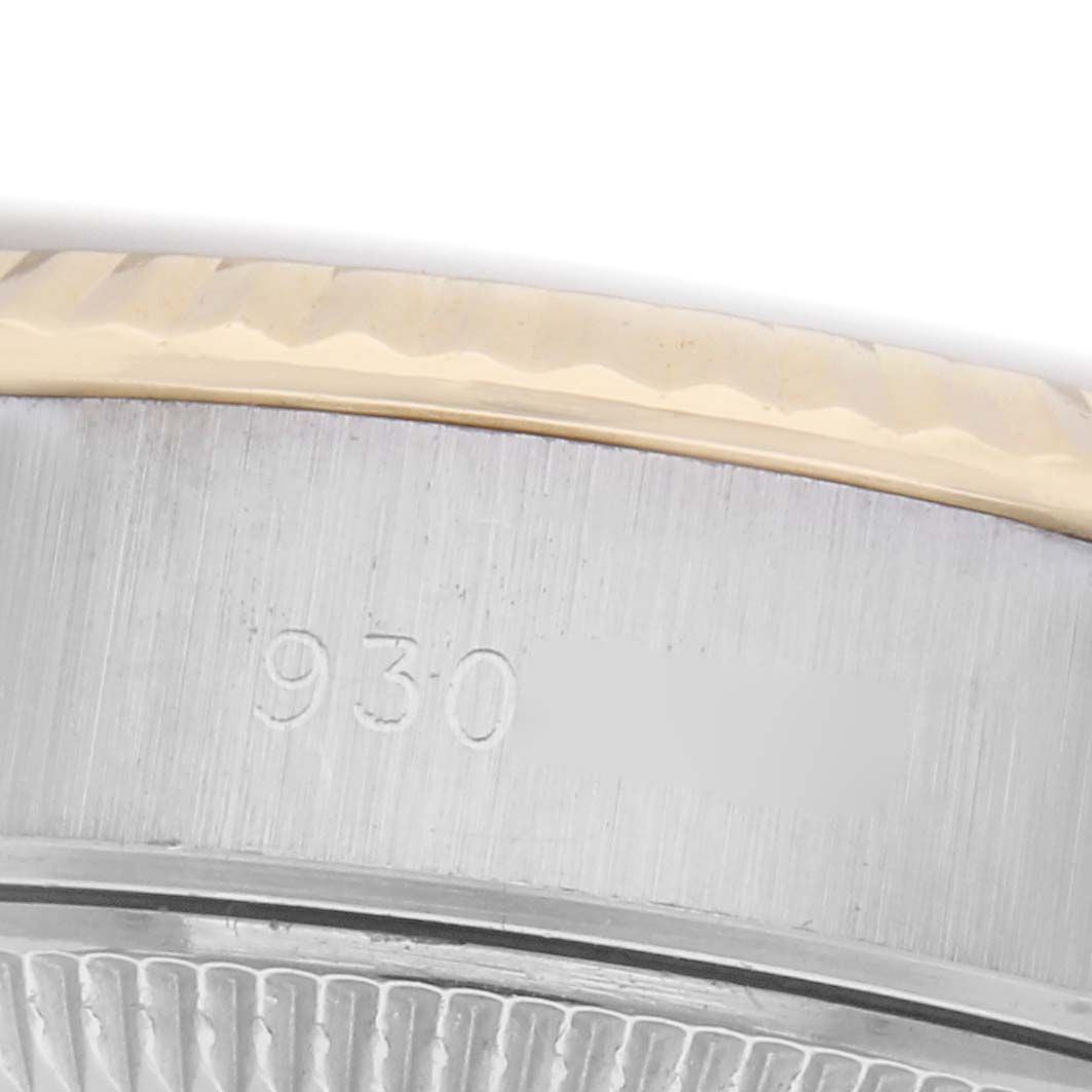 The image shows a close-up of the side of the Rolex Datejust 69173 Women's Steel and Gold (two tone) White Dial 69173 Women's Steel and Gold (two tone) White Dial, highlighting the bezel and part of the case with engraved numbers.