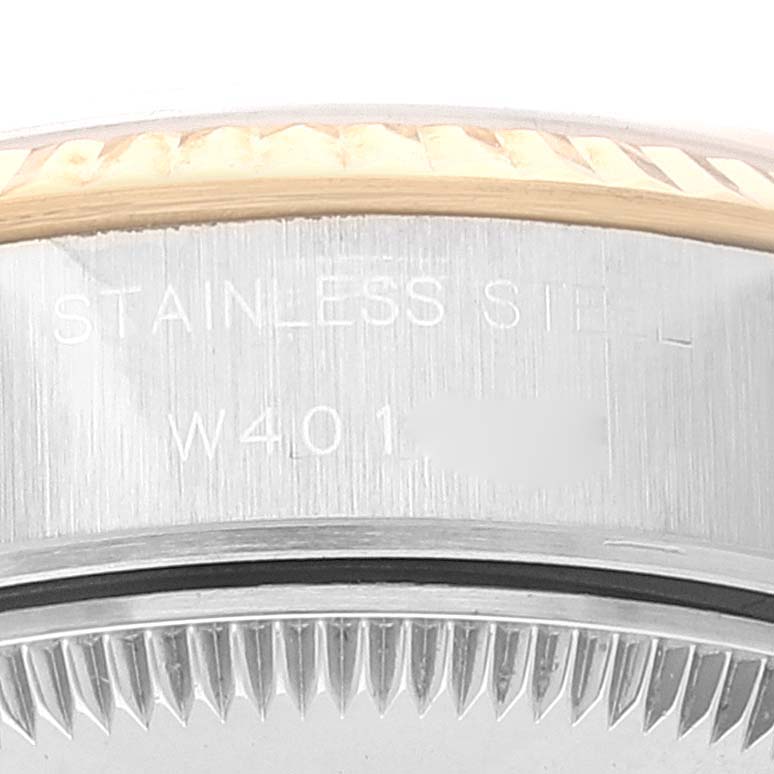 This image shows a close-up of the side and part of the bezel of a Rolex Datejust 69173 Women
s Steel and Gold (two tone) White Dial 69173 Women
s Steel and Gold (two tone) White Dial watch, with "STAINLESS STEEL" engraved.