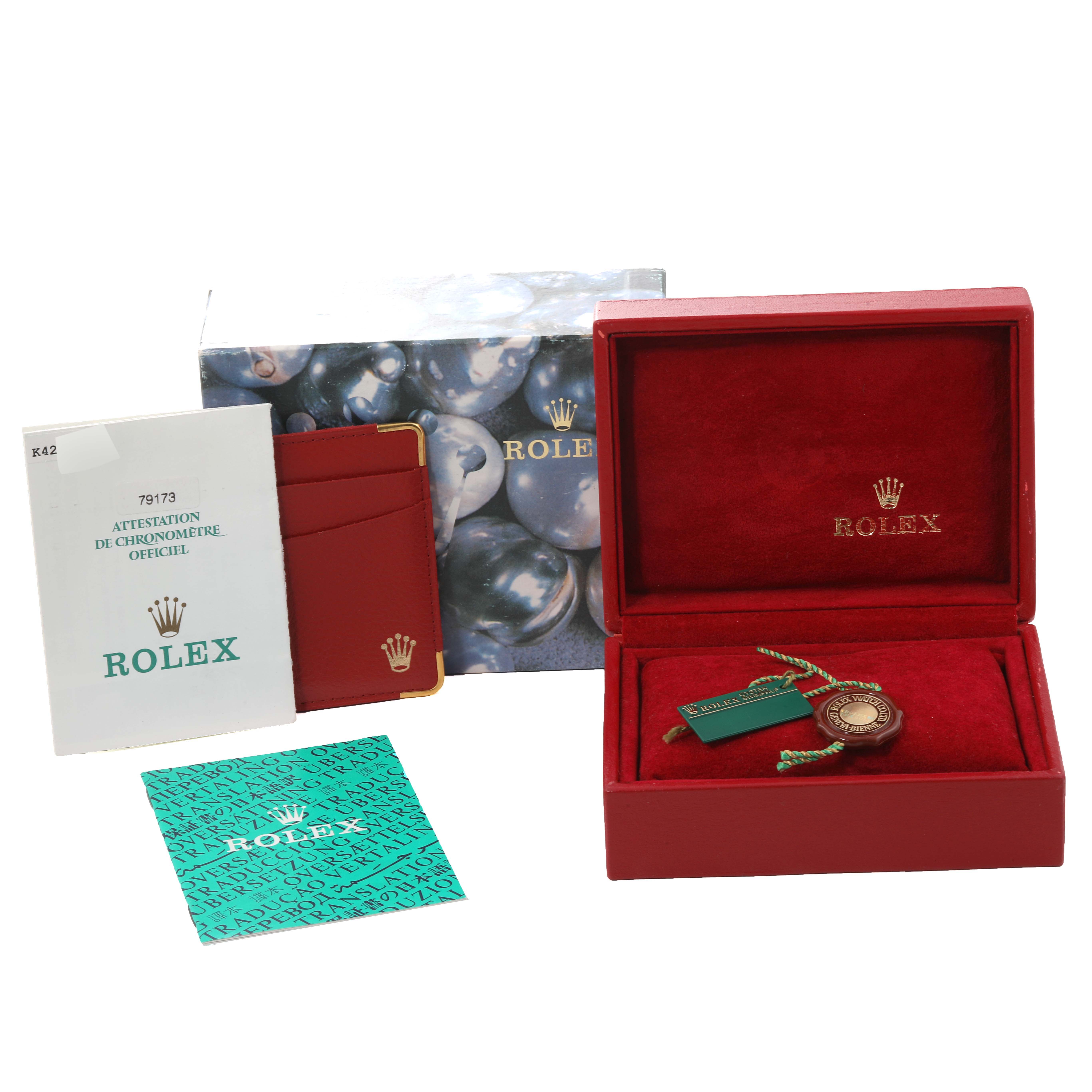 The image shows the packaging and accessories for a Rolex Datejust 79173 Women's Steel and Gold (two tone) White Dial 79173 Women's Steel and Gold (two tone) White Dial model, including a red box, tags, documentation, and a warranty card.