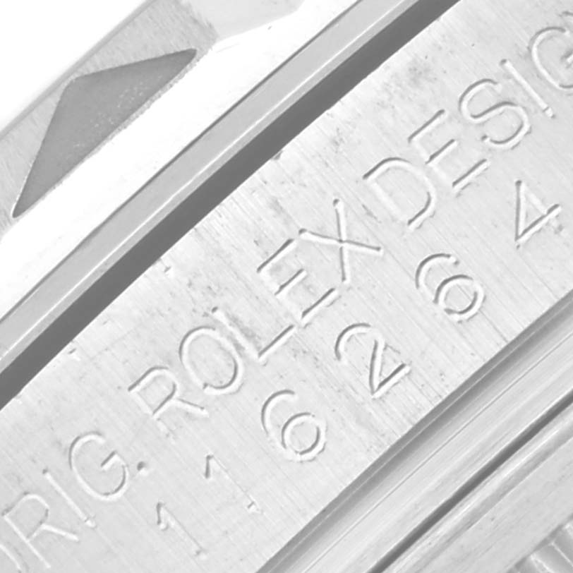 This image shows a close-up of the engraved text on the case back edge of a Rolex Turn-o-Graph 116264 Men's Stainless Steel Black Dial 116264 Men's Stainless Steel Black Dial watch.