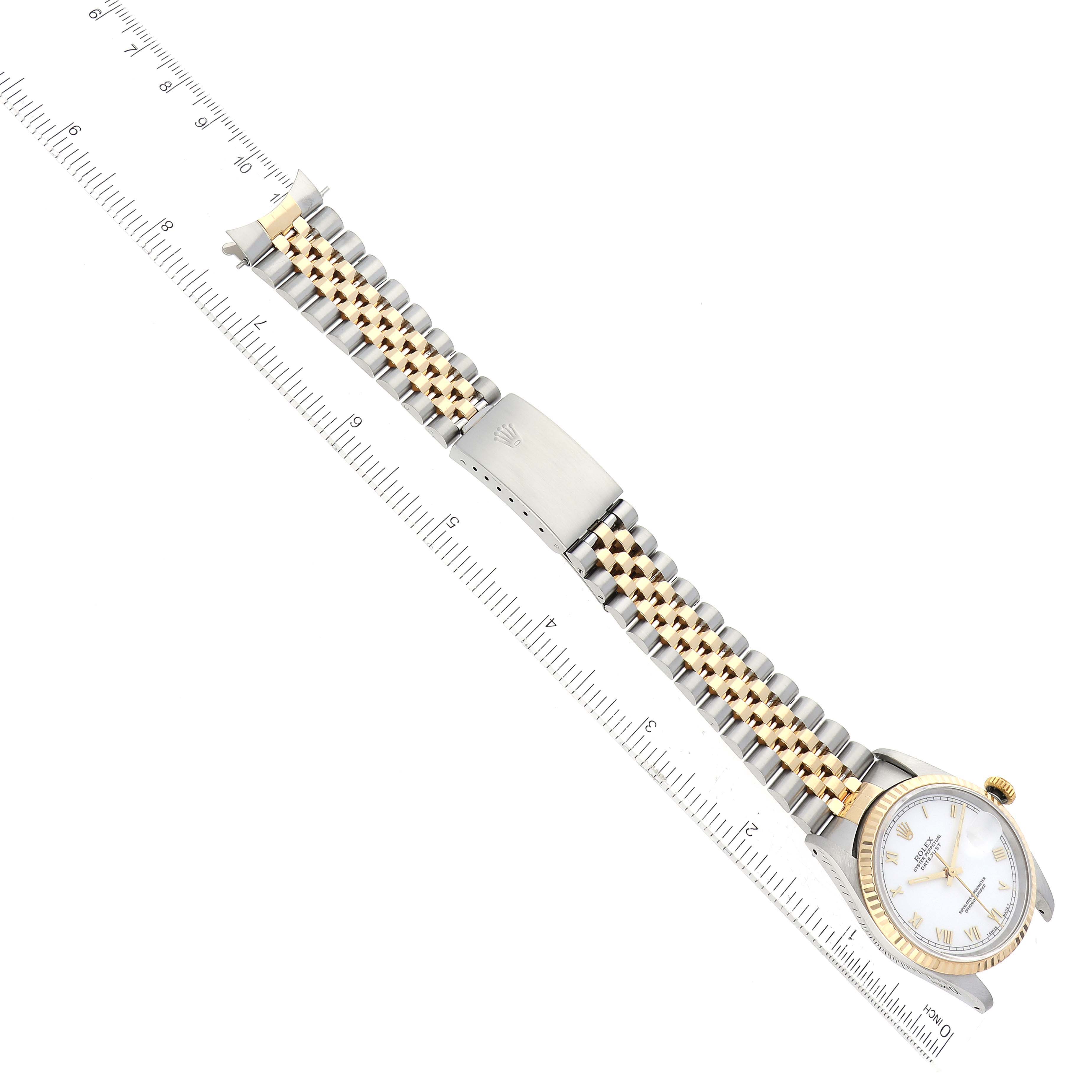 The image shows a Rolex Datejust 16233 Men's Steel and Gold (two tone) White Dial 16233 Men's Steel and Gold (two tone) White Dial watch at a top-down angle, highlighting its gold and silver bracelet, clasp, and white dial.
