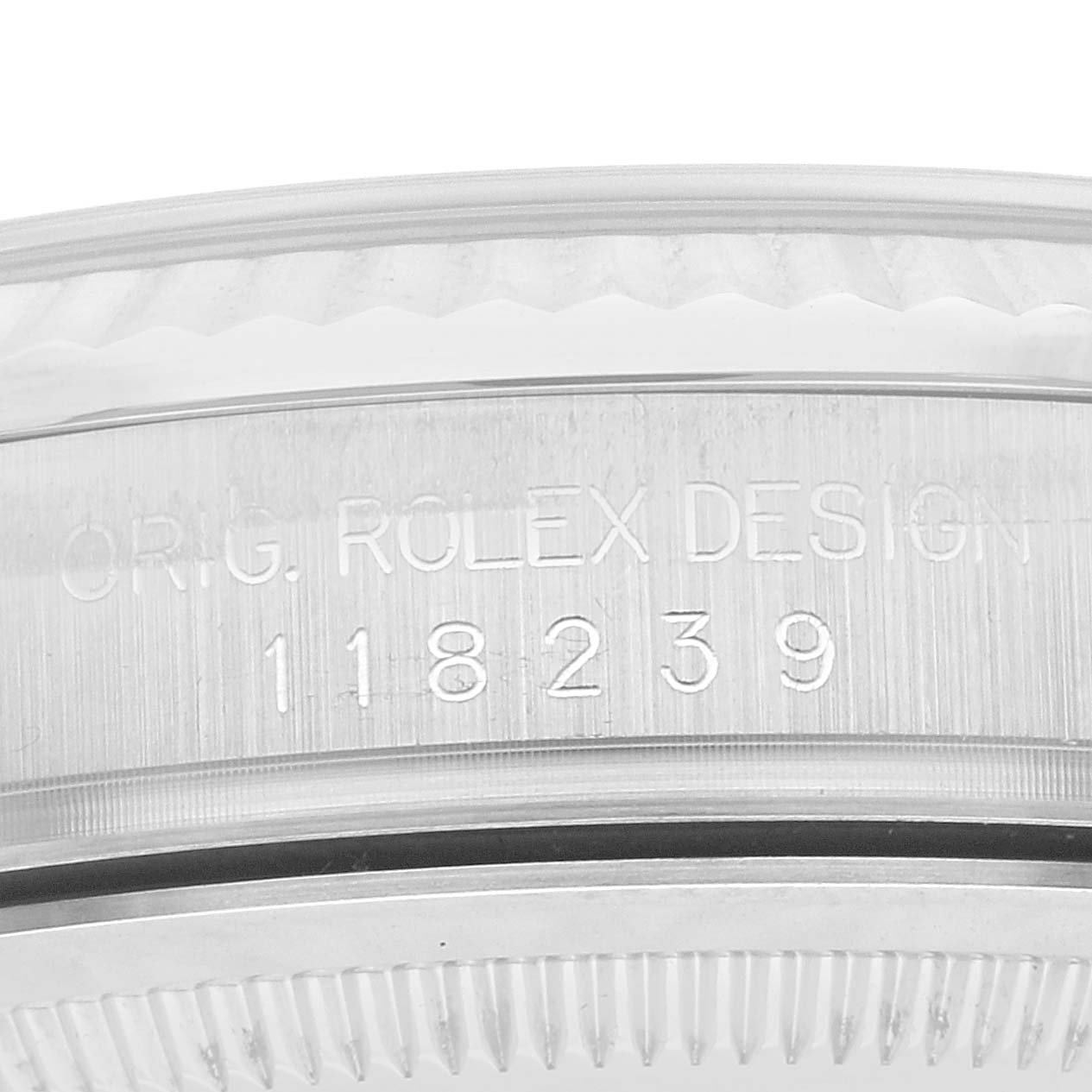 This image shows the side of a Rolex President OFFICIALLY CERTIFIED CHRONOMETER SELF-WINDING MOVEMENT. Men's White Gold Silver Dial OFFICIALLY CERTIFIED CHRONOMETER SELF-WINDING MOVEMENT. Men's White Gold Silver Dial model watch, highlighting its serial number and "ORIG. ROLEX DESIGN" engraving.