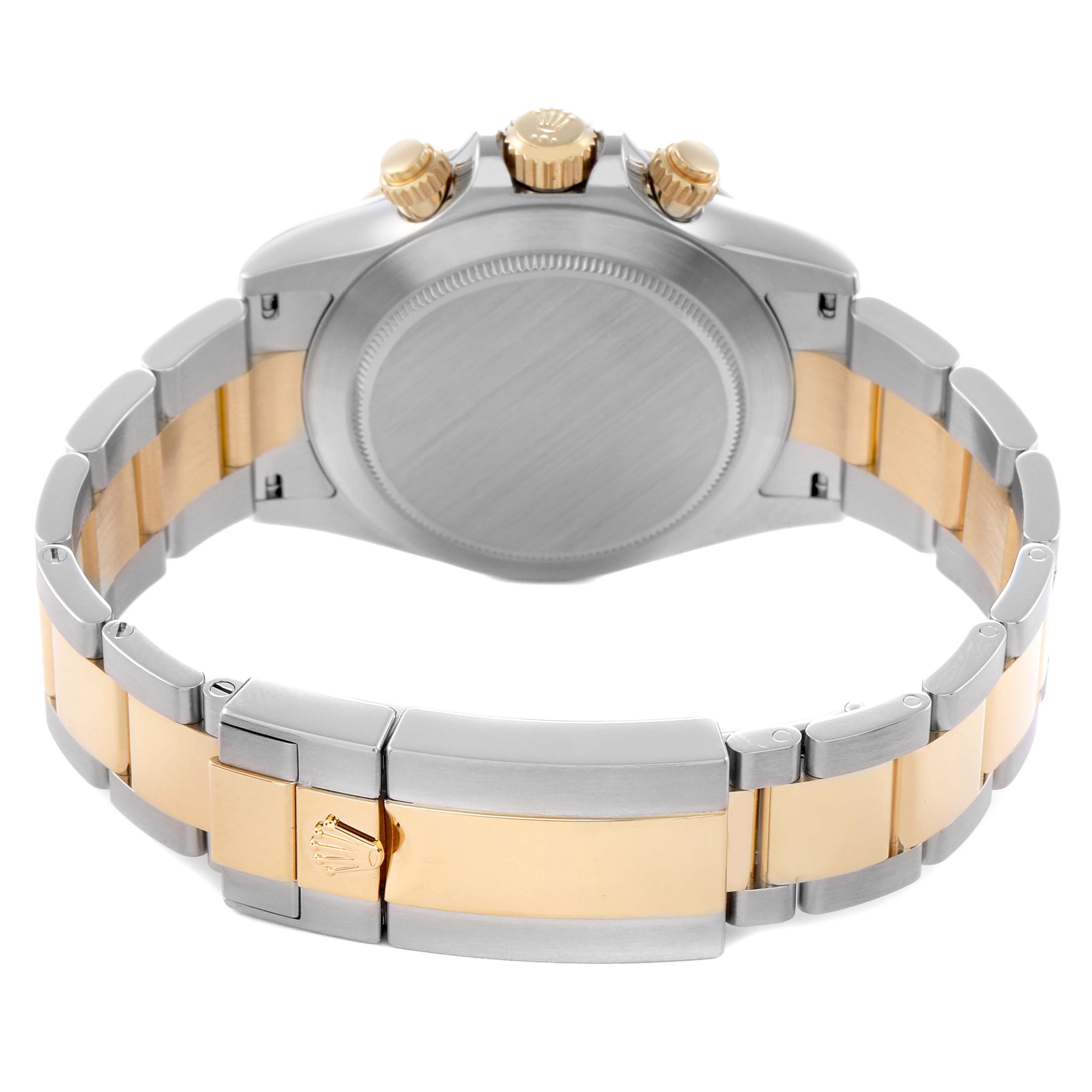 The image shows the back view of a Rolex Daytona 116503 Men
s Steel and Gold (two tone) Mother of Pearl Dial 116503 Men
s Steel and Gold (two tone) Mother of Pearl Dial watch, highlighting the case, crown, and two-tone bracelet.