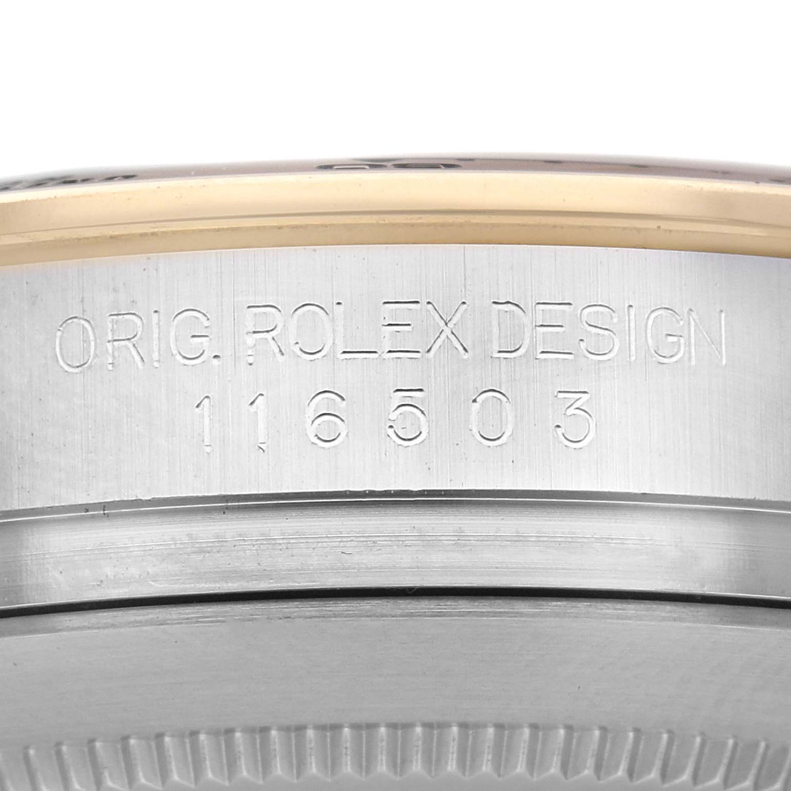 The image shows a close-up of the side of a Rolex Daytona 116503 Men
s Steel and Gold (two tone) Mother of Pearl Dial 116503 Men
s Steel and Gold (two tone) Mother of Pearl Dial, featuring engraved text with the model number.