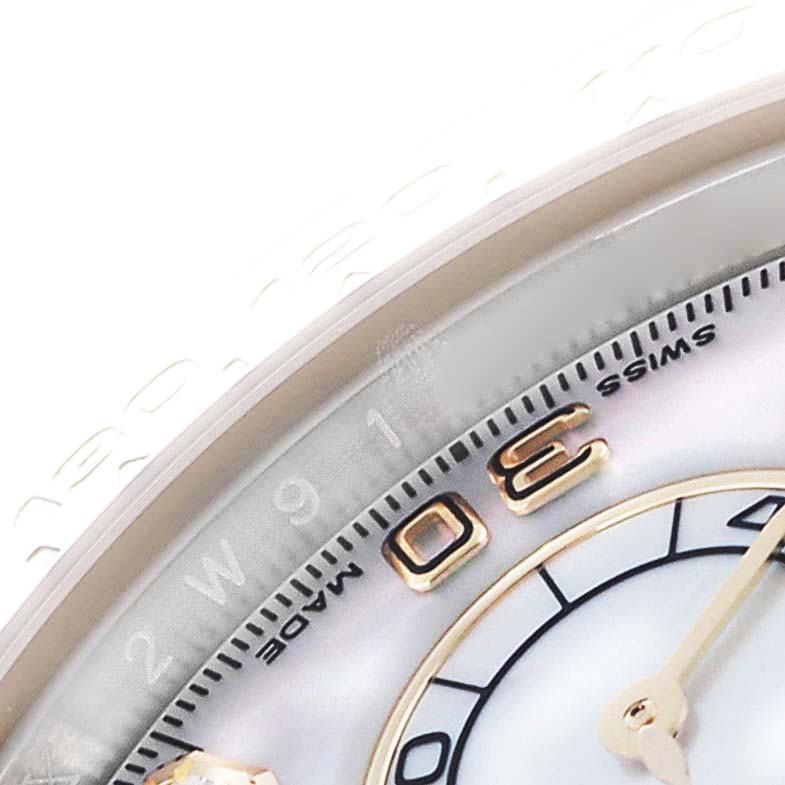 The image shows a close-up of the Rolex Daytona 116503 Men
s Steel and Gold (two tone) Mother of Pearl Dial 116503 Men
s Steel and Gold (two tone) Mother of Pearl Dial dial, highlighting its edge, part of the numerals, and the surrounding bezel.