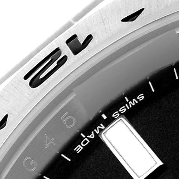 This image shows a close-up of the bezel and partial dial of the Rolex Explorer 216570 Men's Stainless Steel Black Dial 216570 Men's Stainless Steel Black Dial watch, highlighting the "Swiss Made" text.