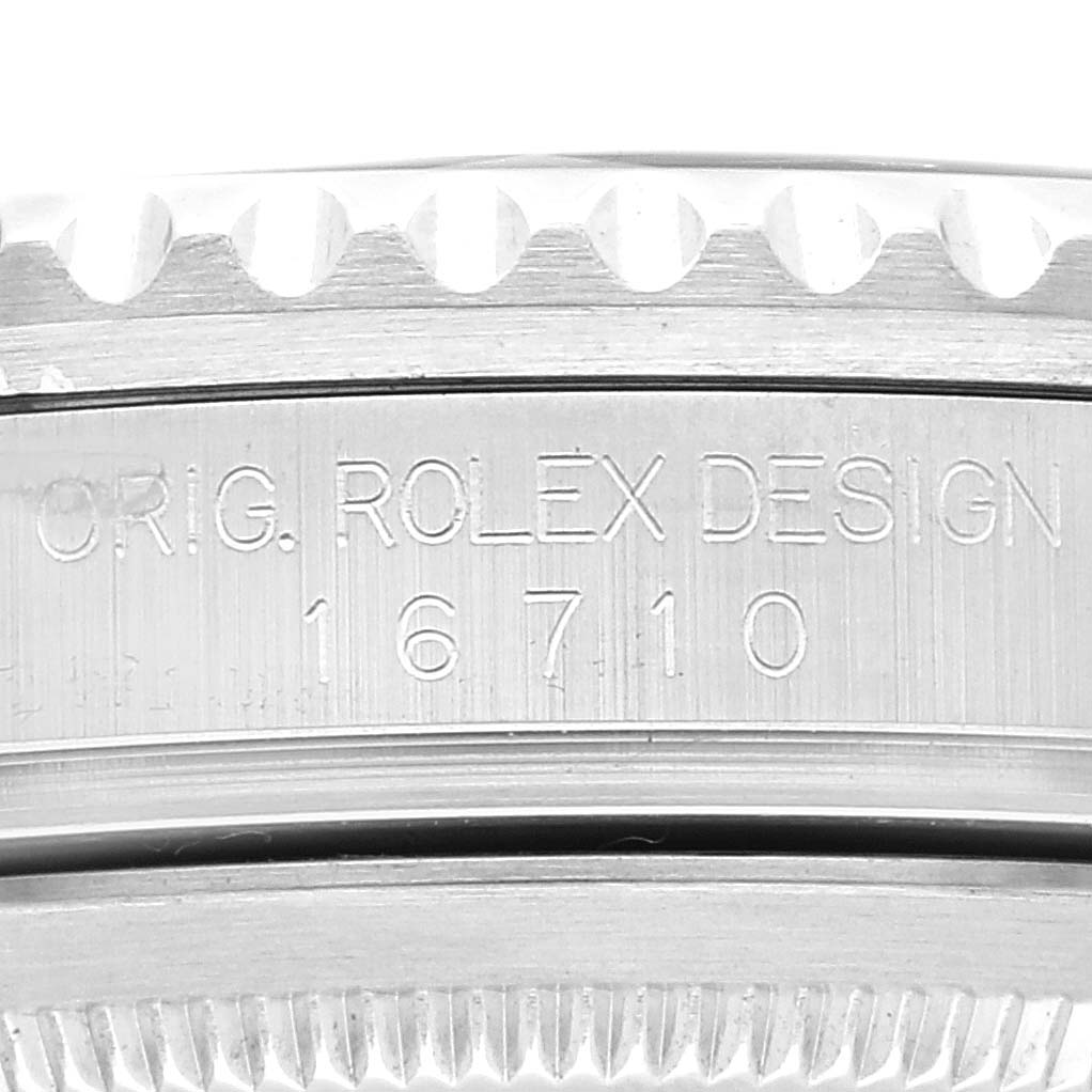 The image shows a close-up angle of the side of a Rolex GMT-Master 16710 Men
s Stainless Steel Black Dial 16710 Men
s Stainless Steel Black Dial watch, highlighting the "ORIG. ROLEX DESIGN" engraving and the model number 16710.