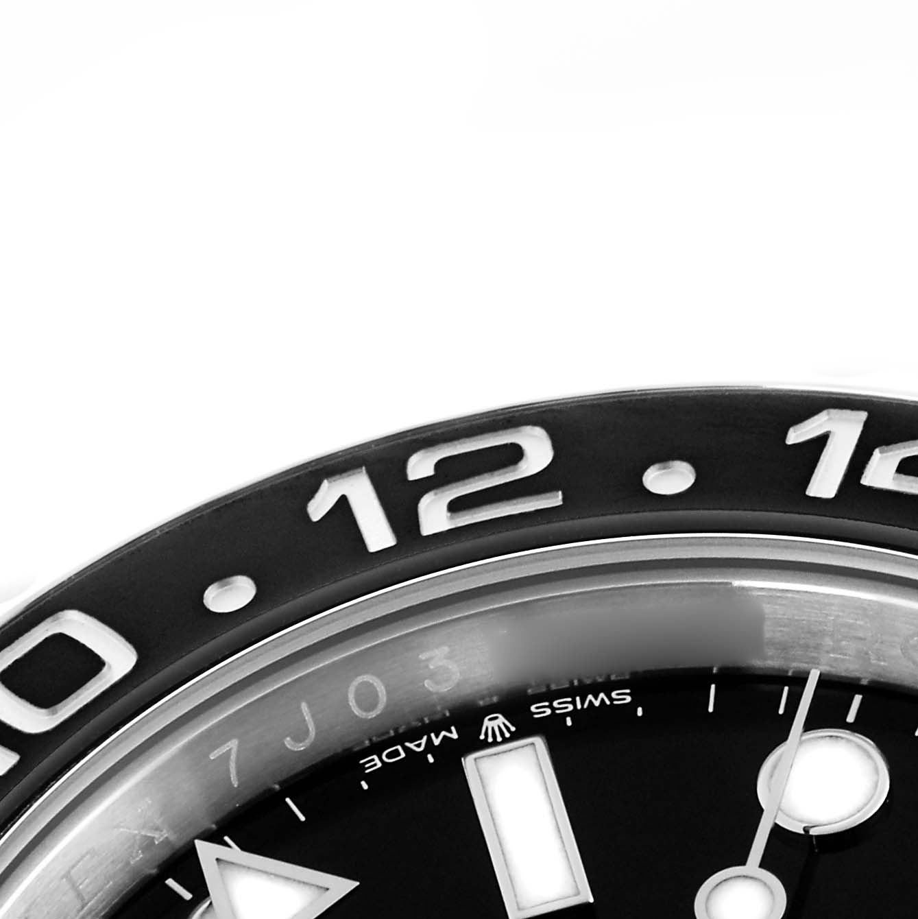The image shows a close-up of the Rolex GMT-Master 126710GRNR Men
s Stainless Steel Black Dial 126710GRNR Men
s Stainless Steel Black Dial
s bezel and part of the dial, viewed from the top angle.