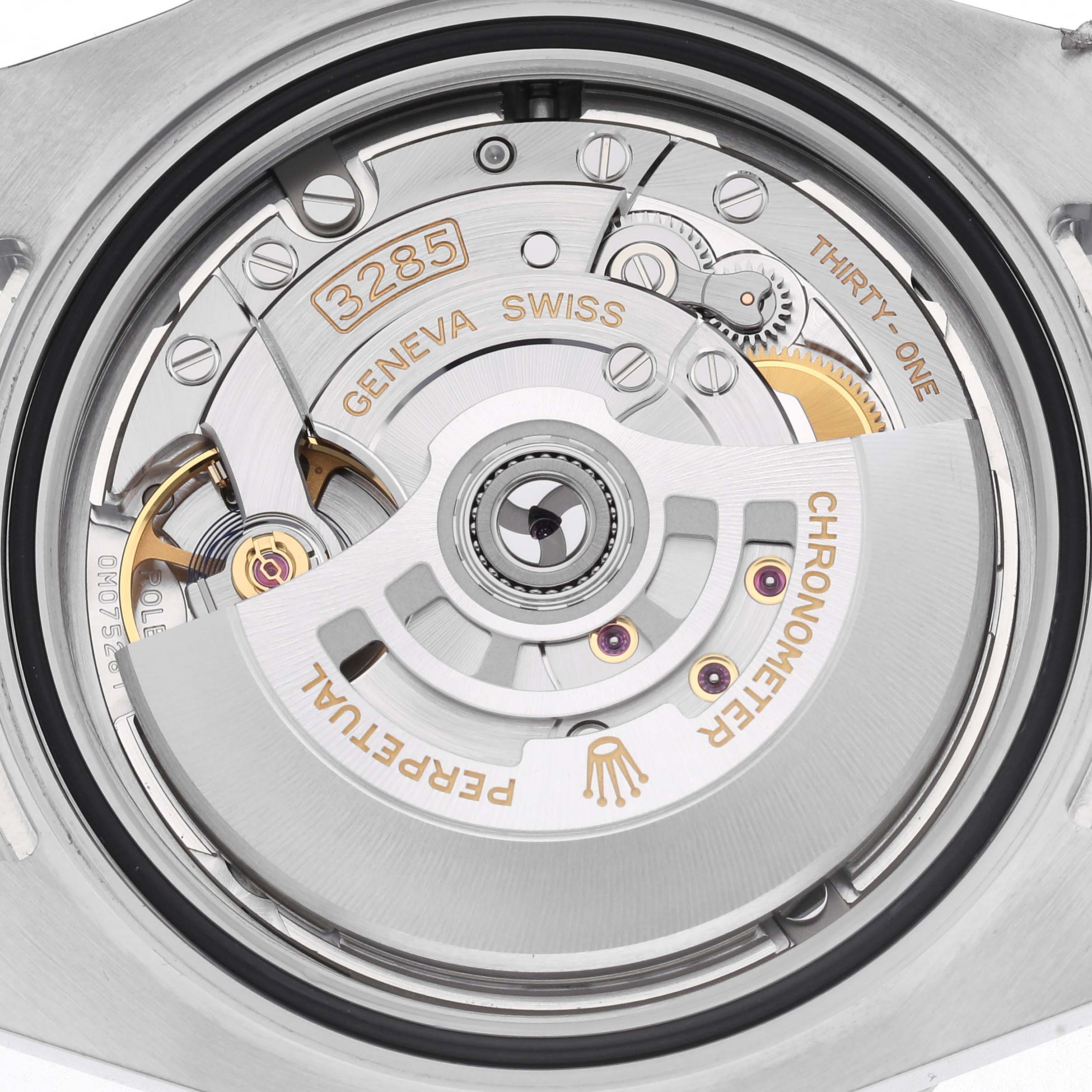 The image shows the intricate movement of a Rolex GMT-Master 126710GRNR Men
s Stainless Steel Black Dial 126710GRNR Men
s Stainless Steel Black Dial watch from a top-down angle, highlighting its mechanism.